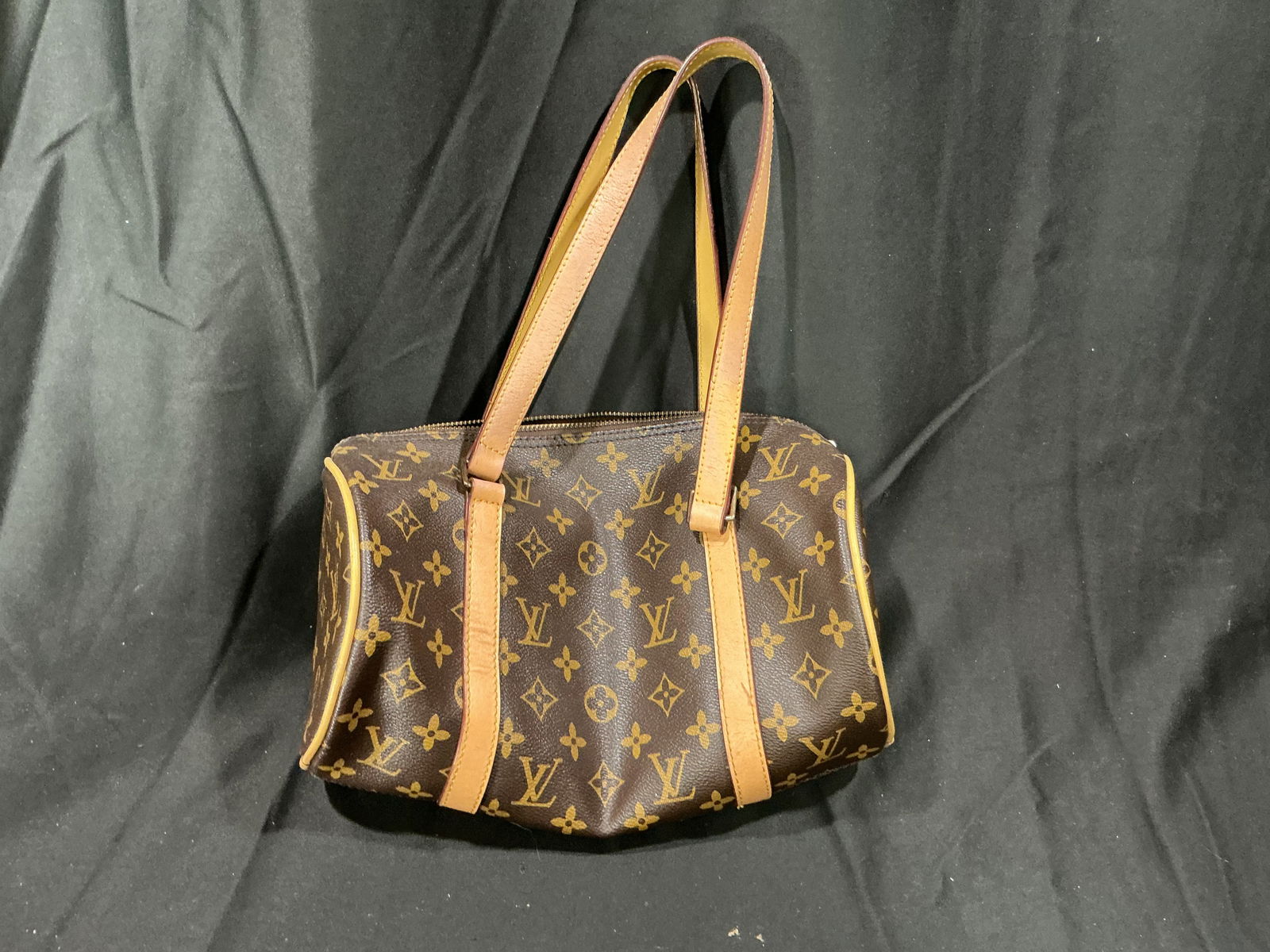 Louis Vuitton Papillon 26 Monogram Canvas Handbag, Made in France: Iconic Louis Vuitton Papillon 26 handbag crafted from the brand's signature Monogram coated canvas with natural vachetta leather trim and dual rolled handles. Features top zip closure with LV