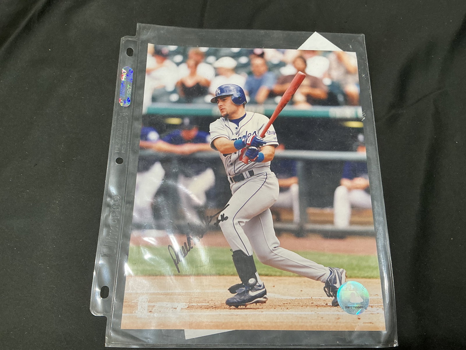 Signed Los Angeles Dodgers Paul Lo Duca Action Photograph with COA: Original action photograph of Los Angeles Dodgers player, Paul Lo Duca, hand-signed and accompanied by a certificate of authenticity. Housed in protective sleeve. Signature and hologram visible.