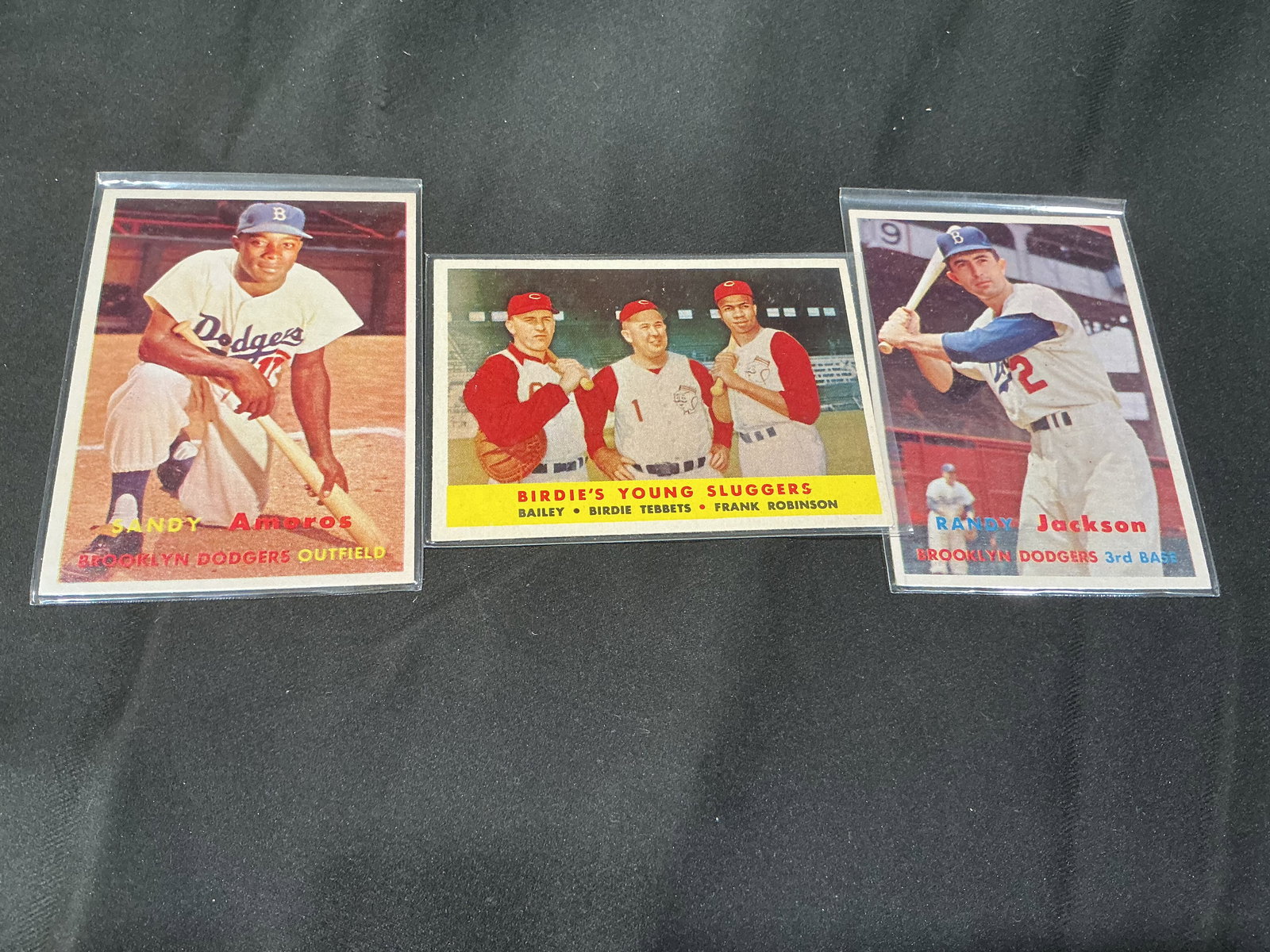 Vintage Brooklyn Dodgers Baseball Card Trio – Sandy Amoros, Birdie’s Young Sluggers, Randy: Group of three vintage Brooklyn Dodgers baseball cards including Sandy Amoros, Birdie’s Young Sluggers (Bailey, Tebbetts, Frank Robinson), and Randy Jackson. Mid-century Topps era cards showcasing c