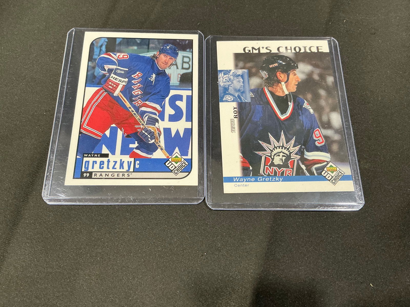 Two Wayne Gretzky New York Rangers Hockey Cards (UD Choice): Two Wayne Gretzky hockey cards featuring his New York Rangers era, including UD Choice/Upper Deck inserts (e.g., StarQuest and GM's Choice styles). Includes two cards in protective