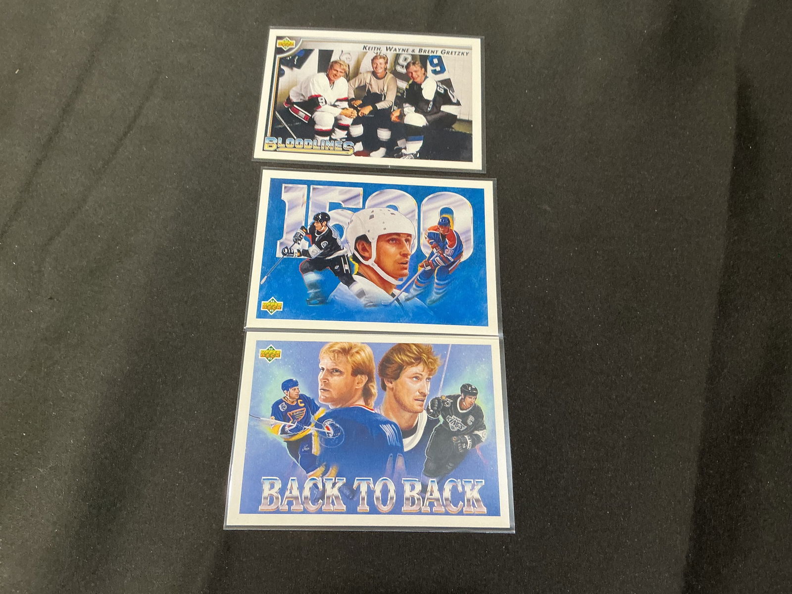 Three Wayne Gretzky Upper Deck Inserts (Bloodlines, 1500, Back-to-Back): Group of three Wayne Gretzky themed hockey trading cards, including Upper Deck insert/specialty cards: "Bloodlines" (Keith, Wayne & Brent Gretzky), "Gretzky 1500," and "Back-to-Back." Card numbers