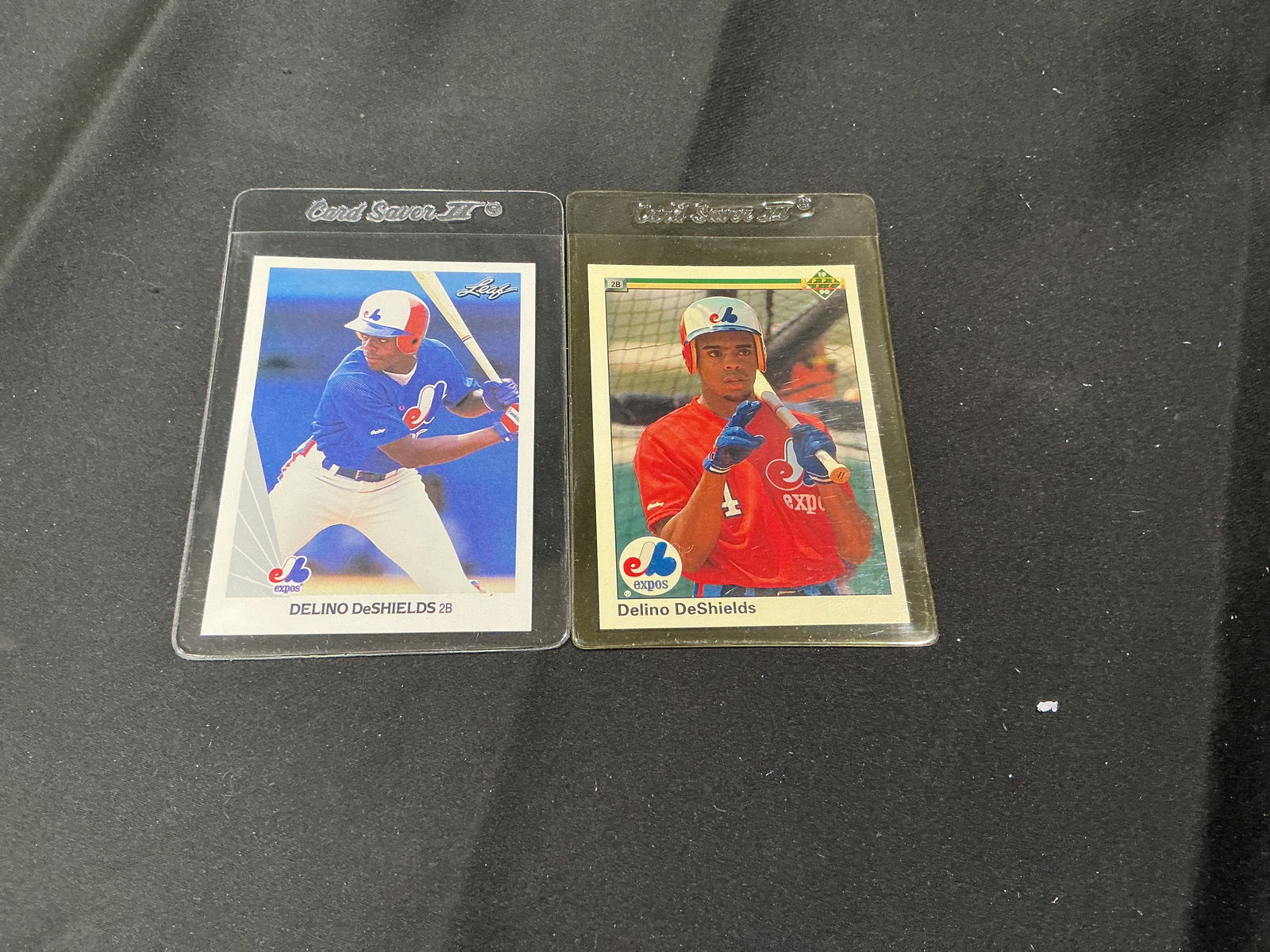 Two Delino DeShields Montreal Expos baseball cards (Leaf & Upper Deck): Lot of two vintage Delino DeShields Montreal Expos baseball trading cards. Includes a Leaf card (#193 visible on back) and an Upper Deck card (#746 visible on back). Great group for Expos collectors