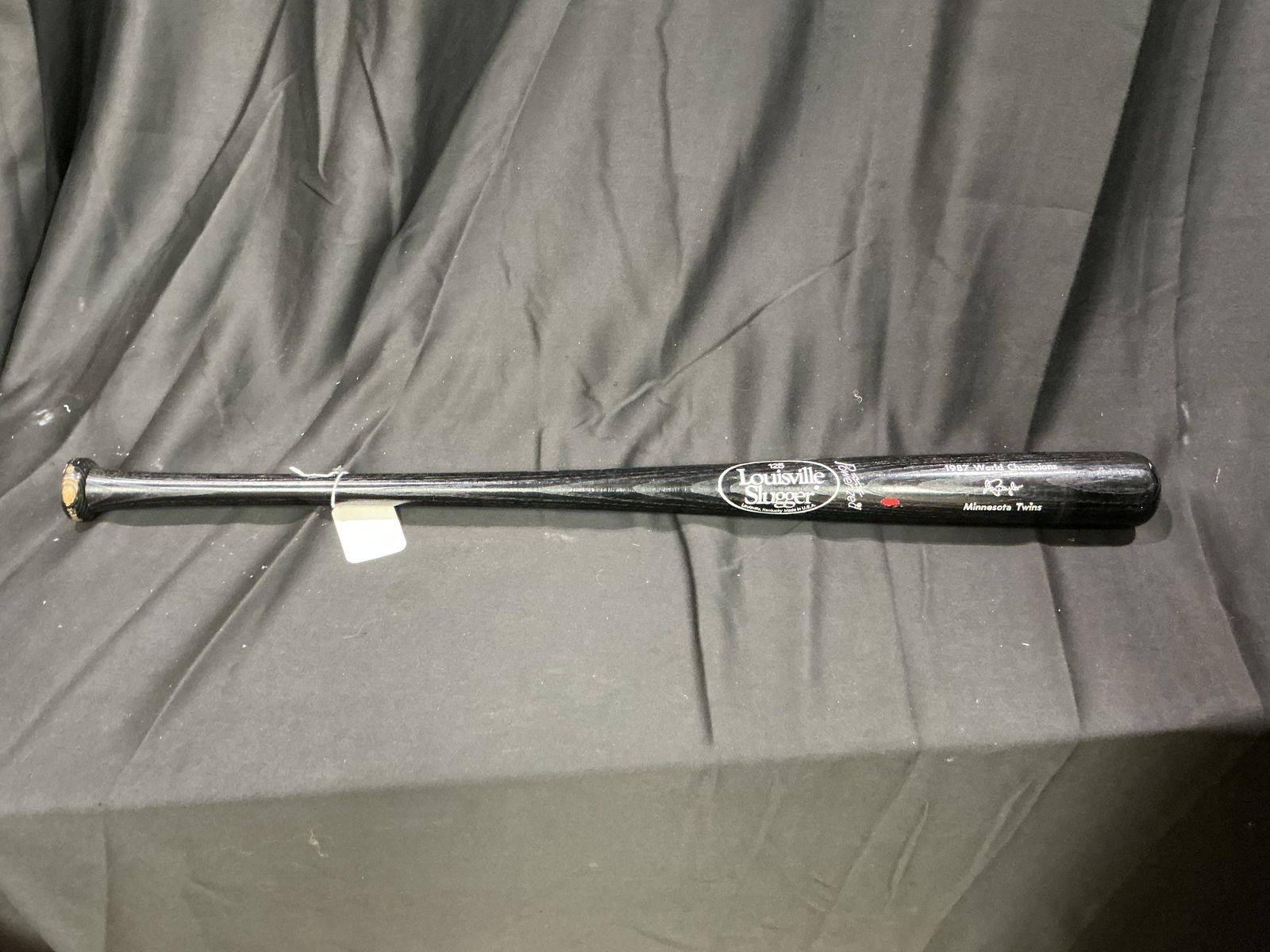 Louisville Slugger 1987 Minnesota Twins World Champions Commemorative Bat: Louisville Slugger Model 125 black-finish commemorative bat celebrating the Minnesota Twins' 1987 World Championship. The barrel features factory-applied white lettering including team attribution and