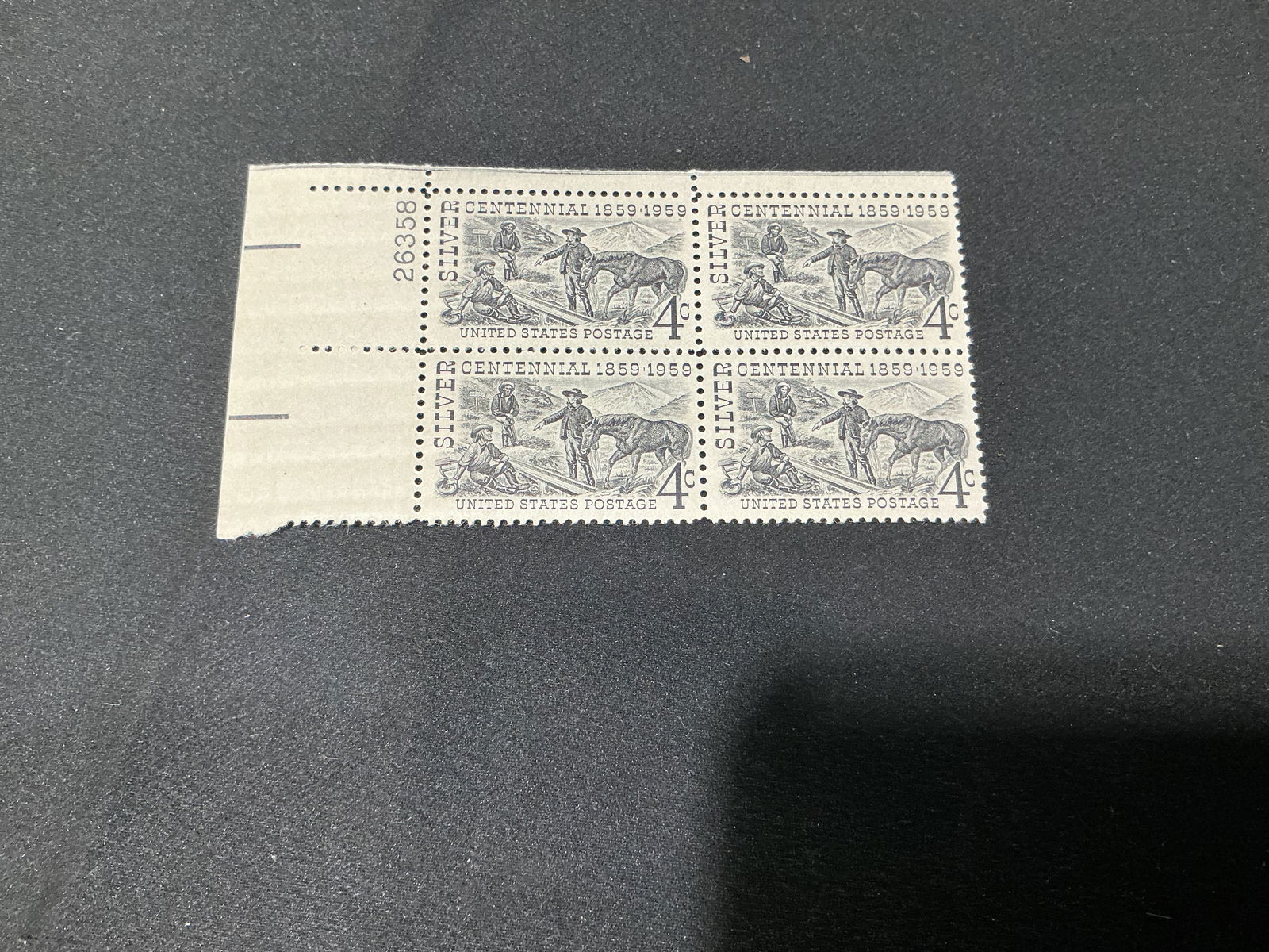 U.S. 4c Nevada Statehood CentennialSilver Centennial plate block of 4: Nevada Statehood Centennial issue (Silver Centennial), 4c denomination. Plate block of four with attached selvage and plate number, as pictured.