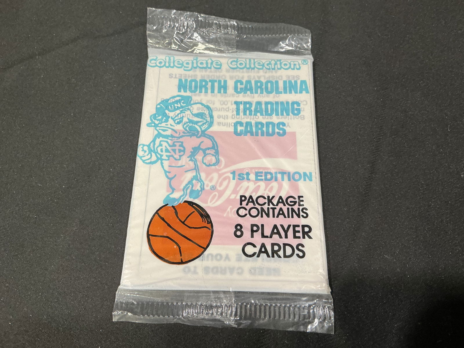 North Carolina Tar Heels Collegiate Collection Sealed Trading Card Pack: Sealed Collegiate Collection North Carolina Tar Heels trading card pack labeled 1st Edition. Pack contains 8 player cards and features UNC Tar Heels basketball branding. Vintage collegiate licensed tr