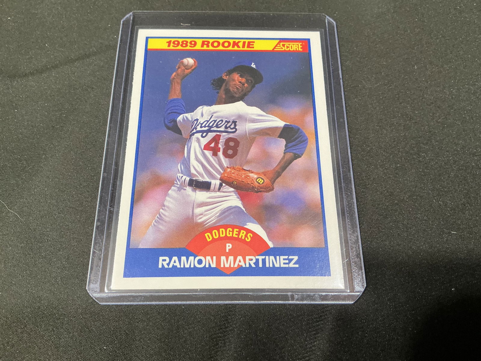 1989 Score Ramon Martinez Los Angeles Dodgers Rookie Baseball Card: 1989 Score baseball card featuring Los Angeles Dodgers pitcher Ramon Martinez and marked as a rookie card. Classic late 1980s Score design with action photograph on the front and career statistics and