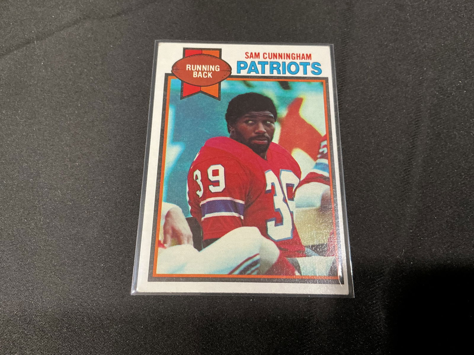 1979 Topps Sam Cunningham New England Patriots Football Card #421: Vintage 1979 Topps football card featuring running back Sam Cunningham of the New England Patriots. Classic late-1970s Topps design with player portrait on the front and career statistics and biograph