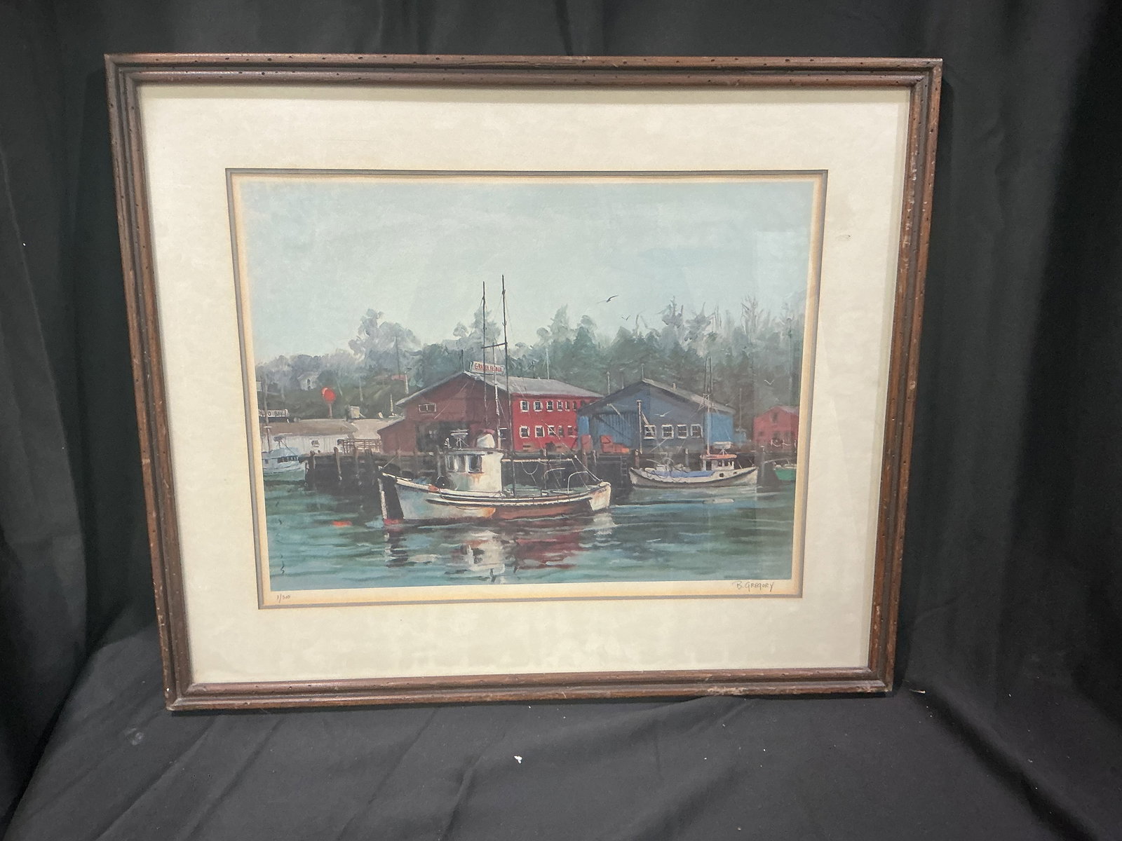 B. Gregory Limited Edition Lithograph Coastal Fishing Village Harbor Scene (1/300): Serene maritime view of a working fishing harbor with colorful weathered buildings (including a prominent red structure) calm reflective water, moored boats, and misty tree-lined shoreline.