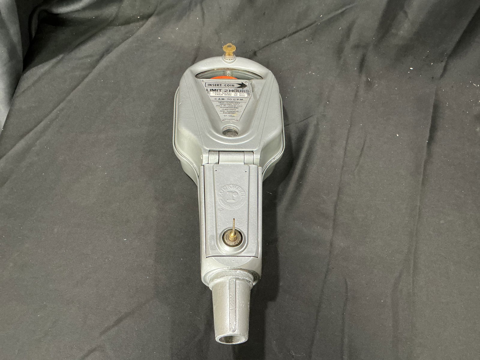 Vintage Duncan Parking Meter with Key: Vintage cast metal parking meter manufactured by Duncan Meter Corporation, featuring yellow-painted body with arched dial marked "Violation." Coin-operated meter accepts 1¢ and 5¢ coins for timed pa