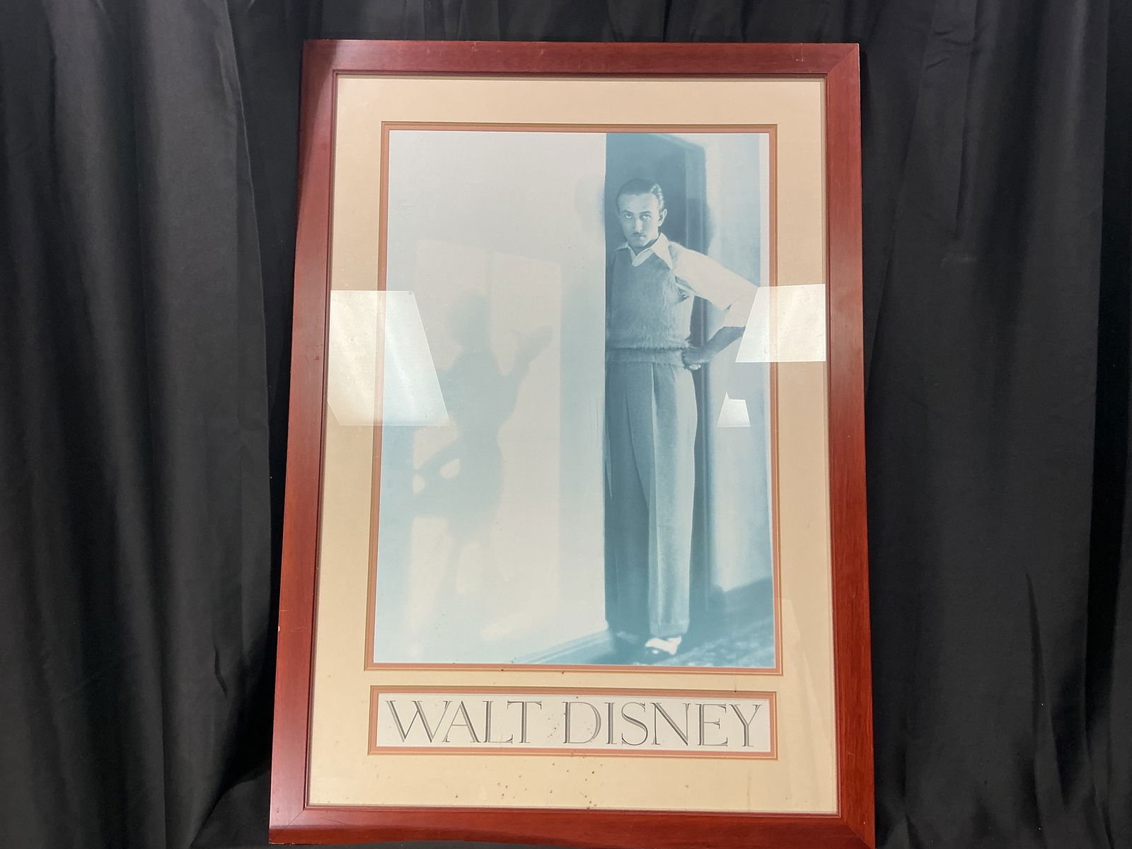 Framed Walt Disney Portrait Print: Framed portrait print depicting Walt Disney standing in a doorway, rendered in a muted monochromatic blue tone with the name Walt Disney printed below the image. The presentation is matted and housed