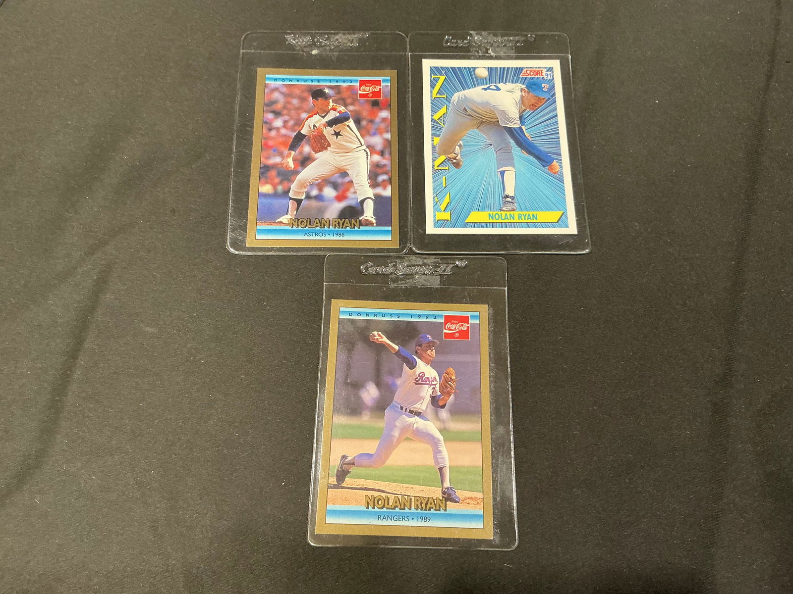 Nolan Ryan Astros Rangers Baseball Card Lot 3 Cards Donruss Coca Cola K-Man: Group of three Nolan Ryan baseball cards featuring the legendary Hall of Fame pitcher with the Astros and Rangers. Includes Donruss Coca-Cola issue and K-Man themed card highlighting Ryan’s dominanc