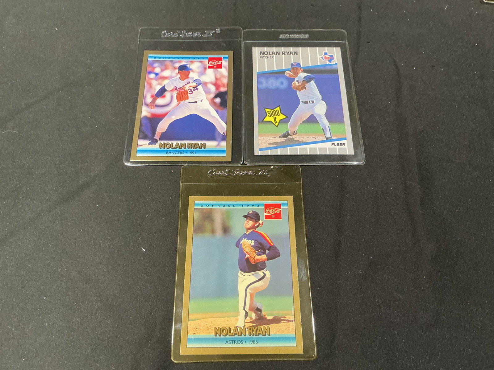 Nolan Ryan Texas Rangers Astros Baseball Card Lot 3 Cards Donruss Fleer Coca Cola: Group of three Nolan Ryan baseball cards featuring Texas Rangers and Houston Astros issues. Includes Donruss Coca Cola series and Fleer cards highlighting one of the greatest pitchers in MLB history.