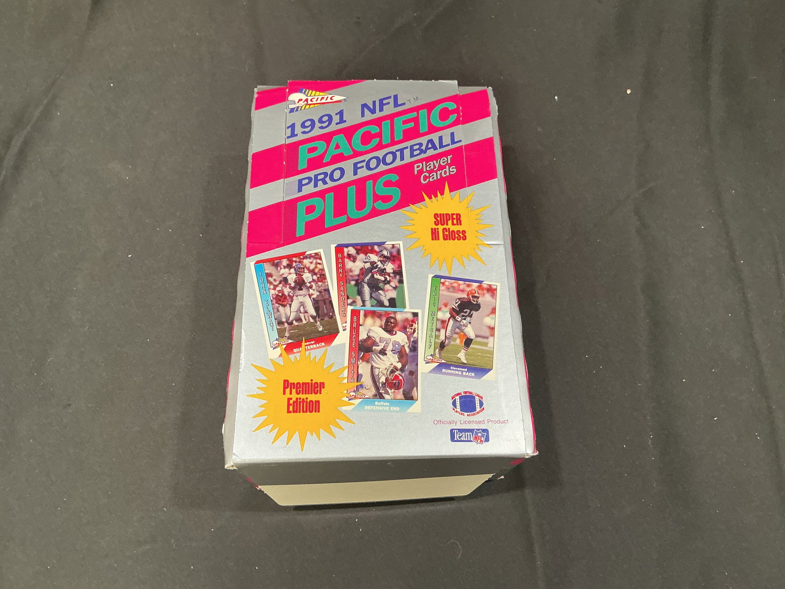 1991 Pacific NFL Pro Football Cards Sealed Box opened: Original 1991 Pacific NFL Pro football trading card box, factory. Features early 1990s NFL players and stars with potential inserts and key cards. Opened product box, but cards packs inside unopened,