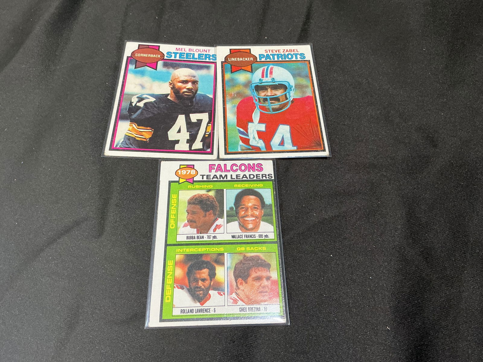 1978 Topps Football Card Lot Mel Blount Steve Zabel Falcons Leaders: Group of three vintage 1978 Topps football cards including Mel Blount (Pittsburgh Steelers), Steve Zabel (New England Patriots), and Falcons Team Leaders checklist card. Classic late-1970s Topps desig