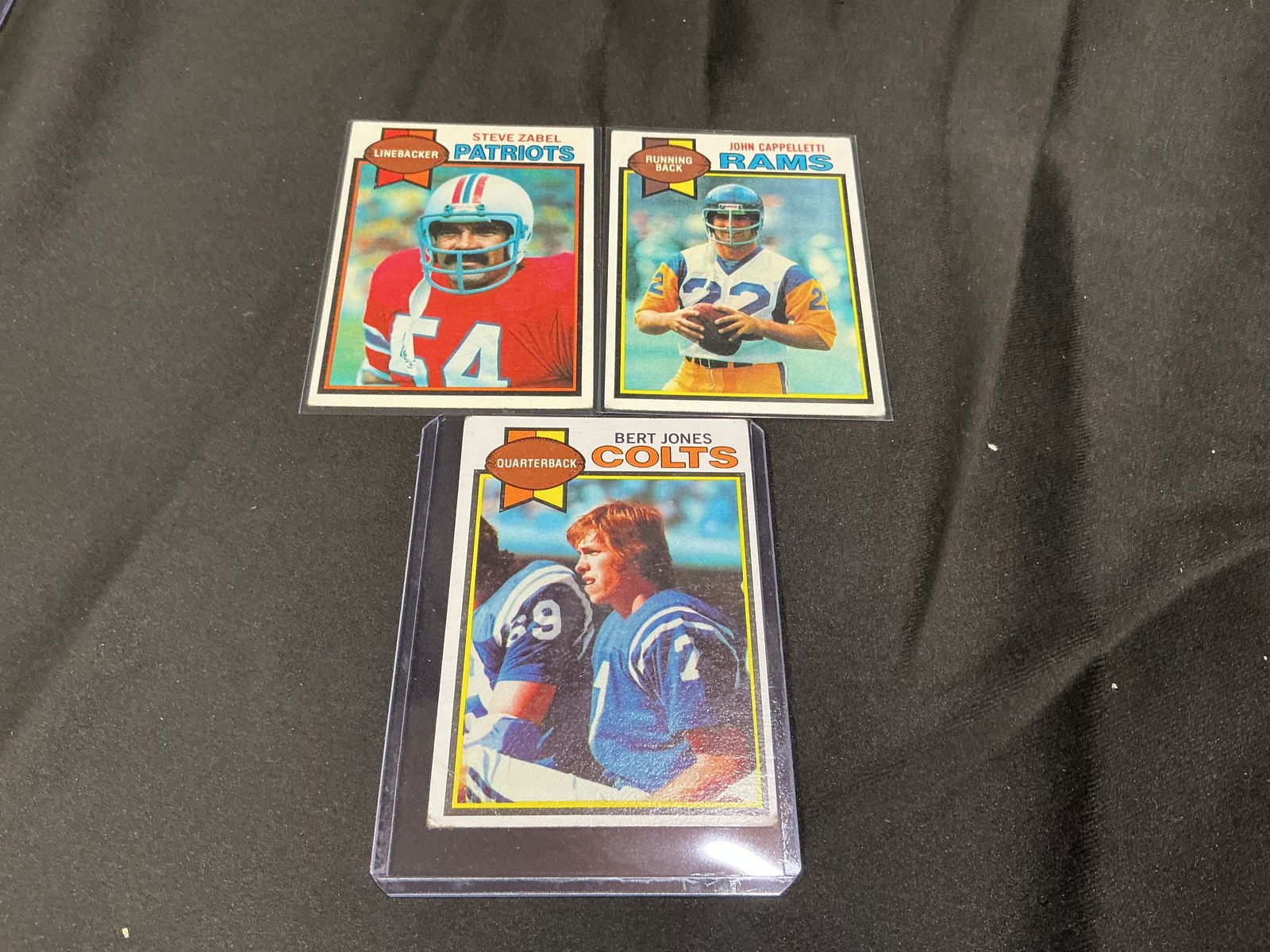 1979 Topps Football Card Lot Steve Zabel John Cappelletti Bert Jones: Group of three 1979 Topps football cards including Steve Zabel (Patriots), John Cappelletti (Rams), and Bert Jones (Colts quarterback). Solid vintage NFL grouping with recognizable names and classic d