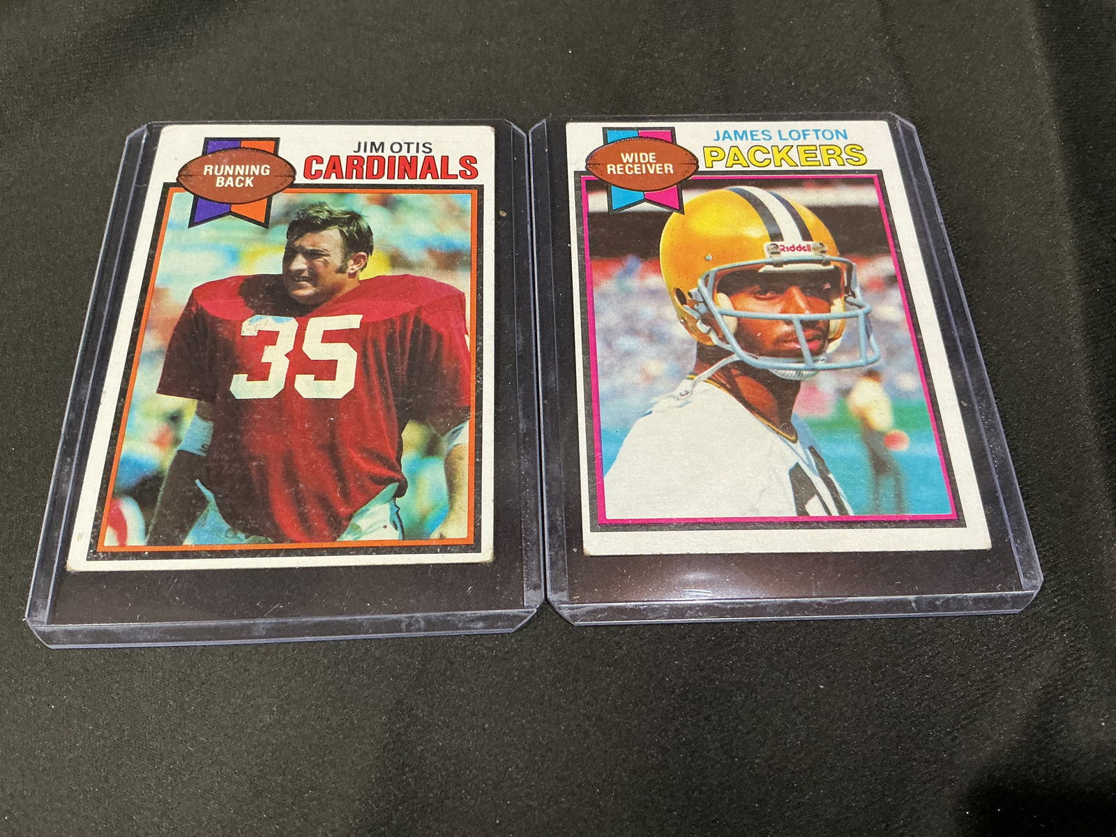 1979 Topps Jim Otis Cardinals & James Lofton Packers Football Cards (2): Pair of 1979 Topps football cards featuring Jim Otis of the St. Louis Cardinals and James Lofton of the Green Bay Packers. Includes Lofton early career issue. Classic late-1970s Topps designs.