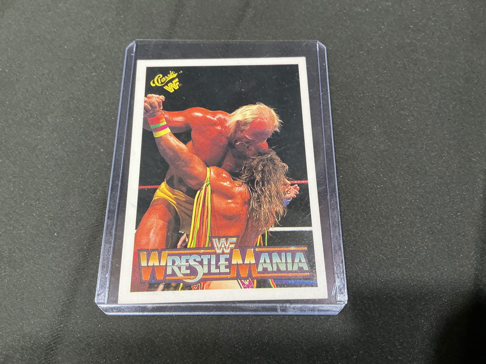 1990 Classic WWF WrestleMania VI Hulk Hogan vs Ultimate Warrior Card: 1990 Classic WWF WrestleMania VI trading card featuring Hulk Hogan and Ultimate Warrior in one of the most iconic matches in wrestling history. Card #133 with WrestleMania VI branding and descriptive