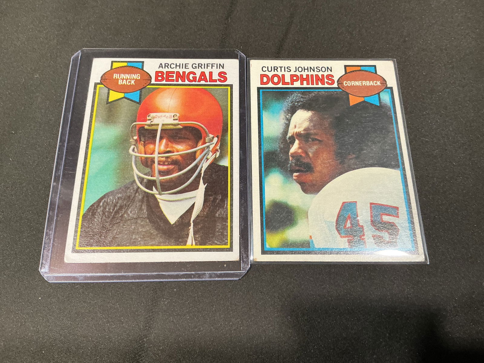 1979 Topps Football Card Pair Archie Griffin and Curtis Johnson (2): Pair of 1979 Topps football cards featuring Archie Griffin (Cincinnati Bengals running back) and Curtis Johnson (Miami Dolphins cornerback). Classic late-1970s Topps football design with statistics an