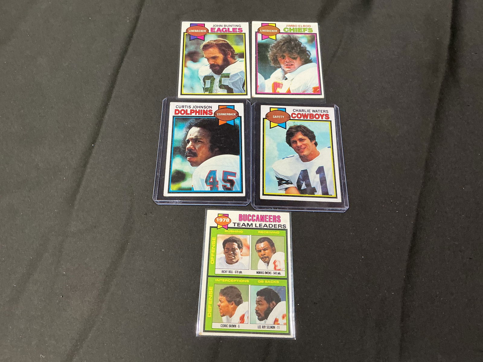 1979 Topps Football Card Group Curtis Johnson, Charlie Waters, John Bunting, Jimbo Elrod, Buccaneers: Group of 1979 Topps football cards including Curtis Johnson (Dolphins), Charlie Waters (Cowboys), John Bunting (Eagles), Jimbo Elrod (Chiefs), and Buccaneers Team Leaders card. Classic late-1970s Topp