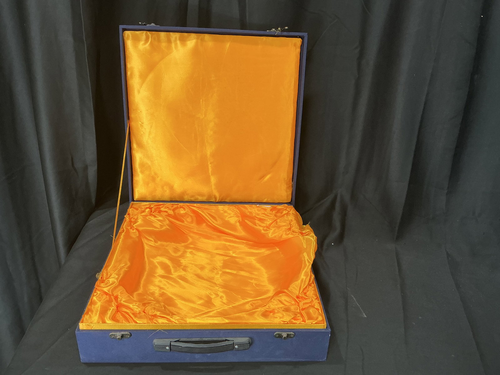 Vintage Blue Presentation Case with Satin Interior: Vintage blue hard case with metal latches and handle, featuring a bright satin-lined interior. Suitable for storage or presentation of documents, collectibles, or instruments.