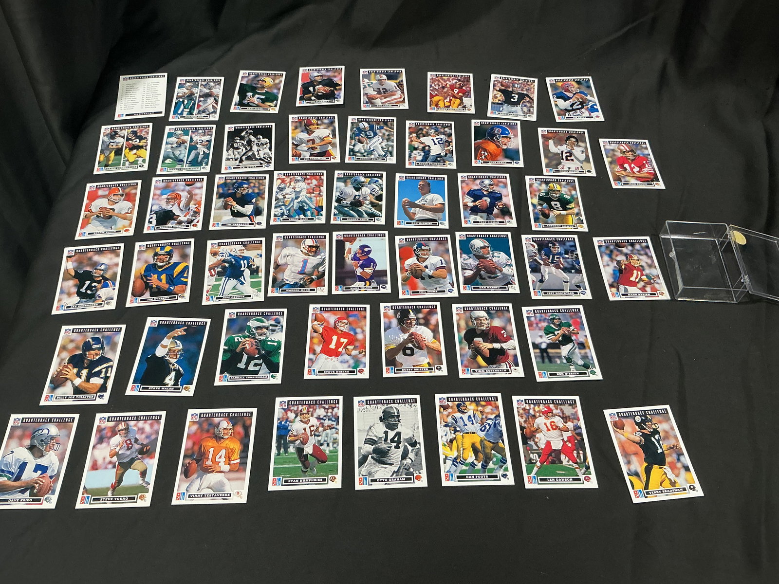 Quarterback Challenge Football Card Lot Vintage NFL Mixed Players Large Group: Large group of vintage Quarterback Challenge football cards featuring multiple NFL quarterbacks and stars. Expanded lot with wide player variety. Includes display case as shown.
