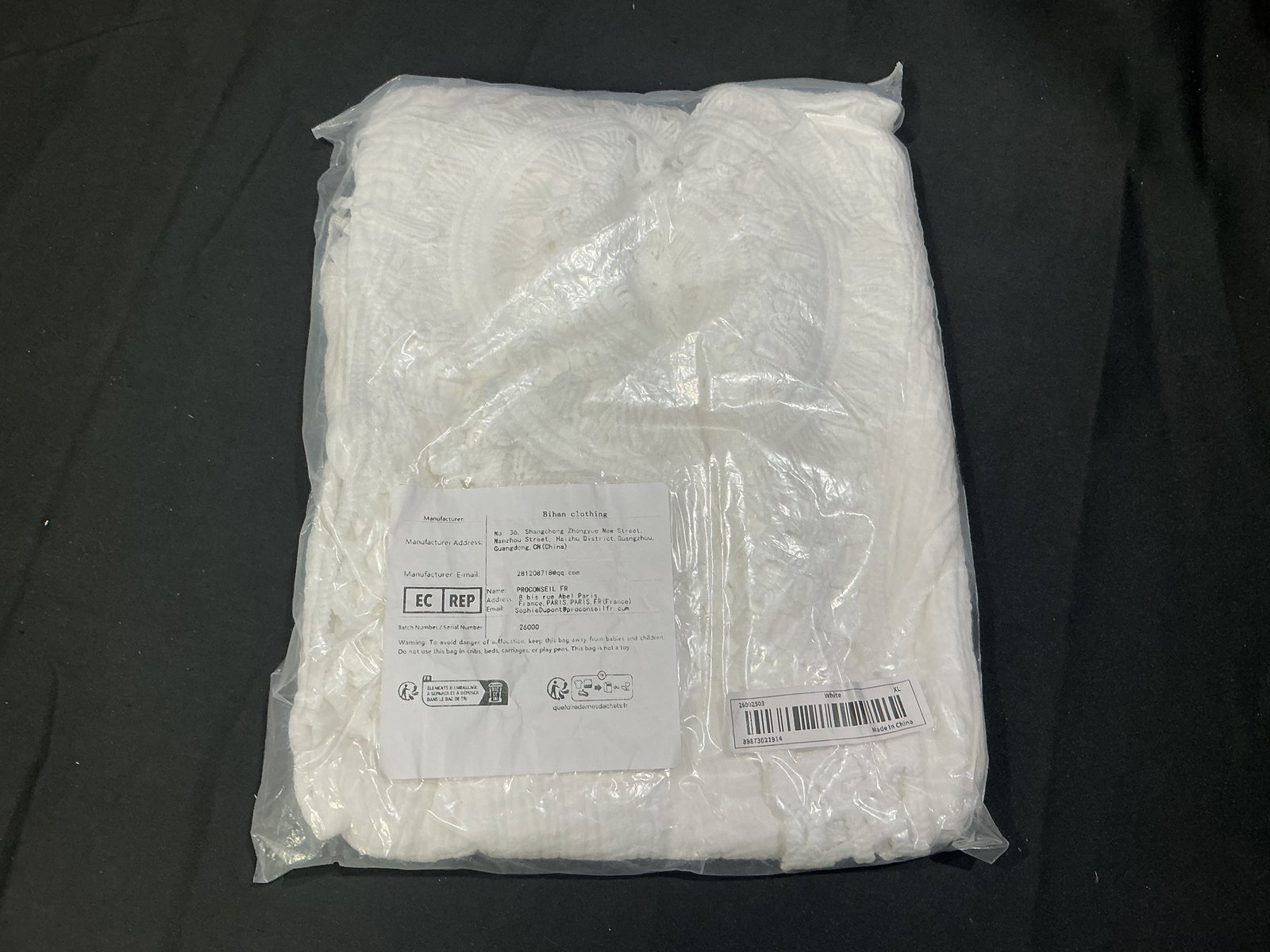 White Textured Lightweight Garment Shawl Wrap Cover Up: White textured lightweight garment with soft crinkled fabric and decorative trim edges. Suitable as a shawl, wrap, or casual cover up. Neutral versatile piece for layering. Presented new in original p