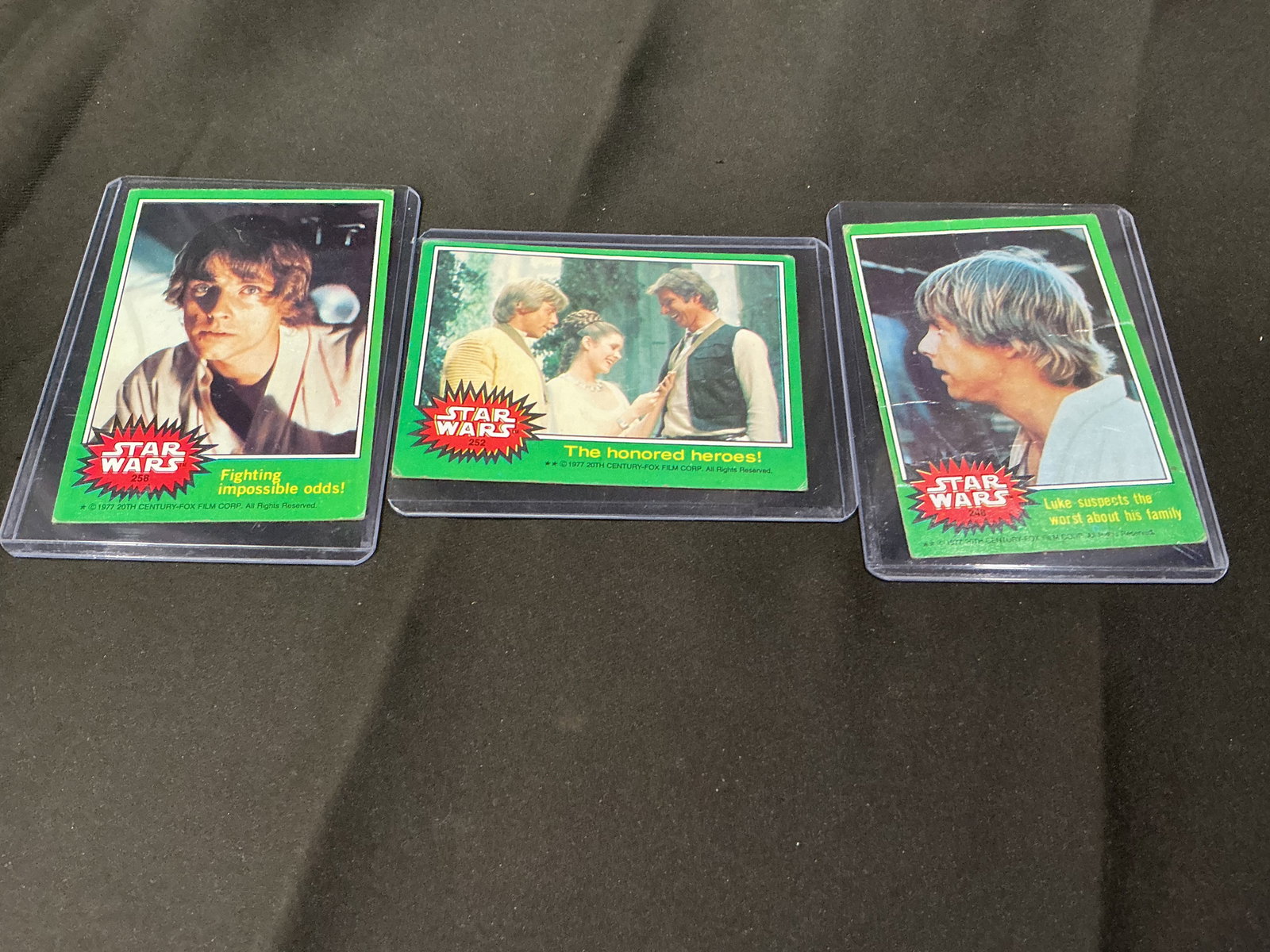 1977 Star Wars Green Border Trading Card Lot: Lot of vintage 1977 Star Wars trading cards featuring classic scenes and characters including Luke Skywalker and key moments from the original film. Green border series with strong nostalgic appeal fo