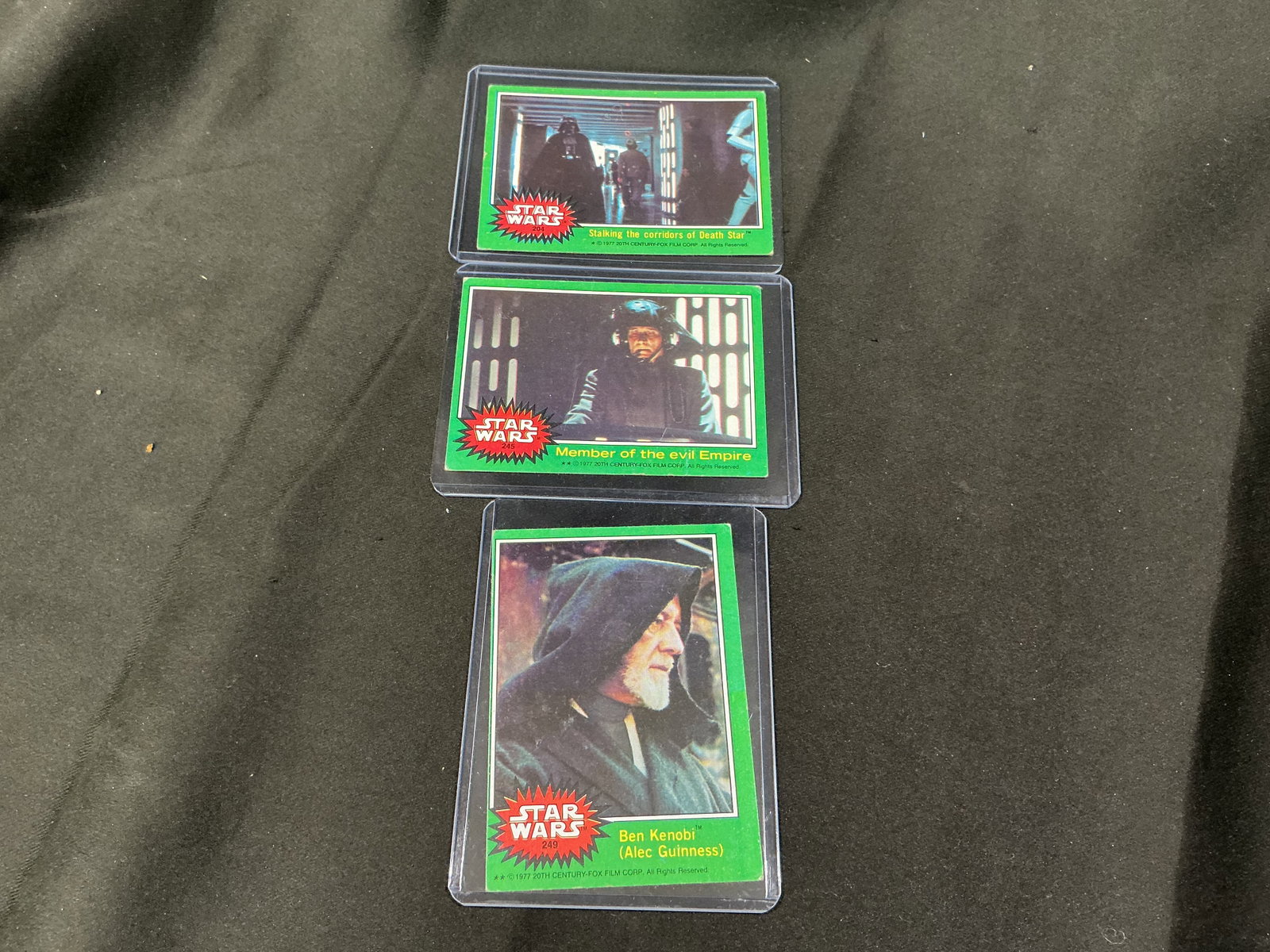 1977 Star Wars Green Series Trading Cards Lot: Group of vintage 1977 Star Wars green series trading cards featuring scenes and characters including Ben Kenobi and Imperial figures. Classic original trilogy imagery with strong nostalgia and collect