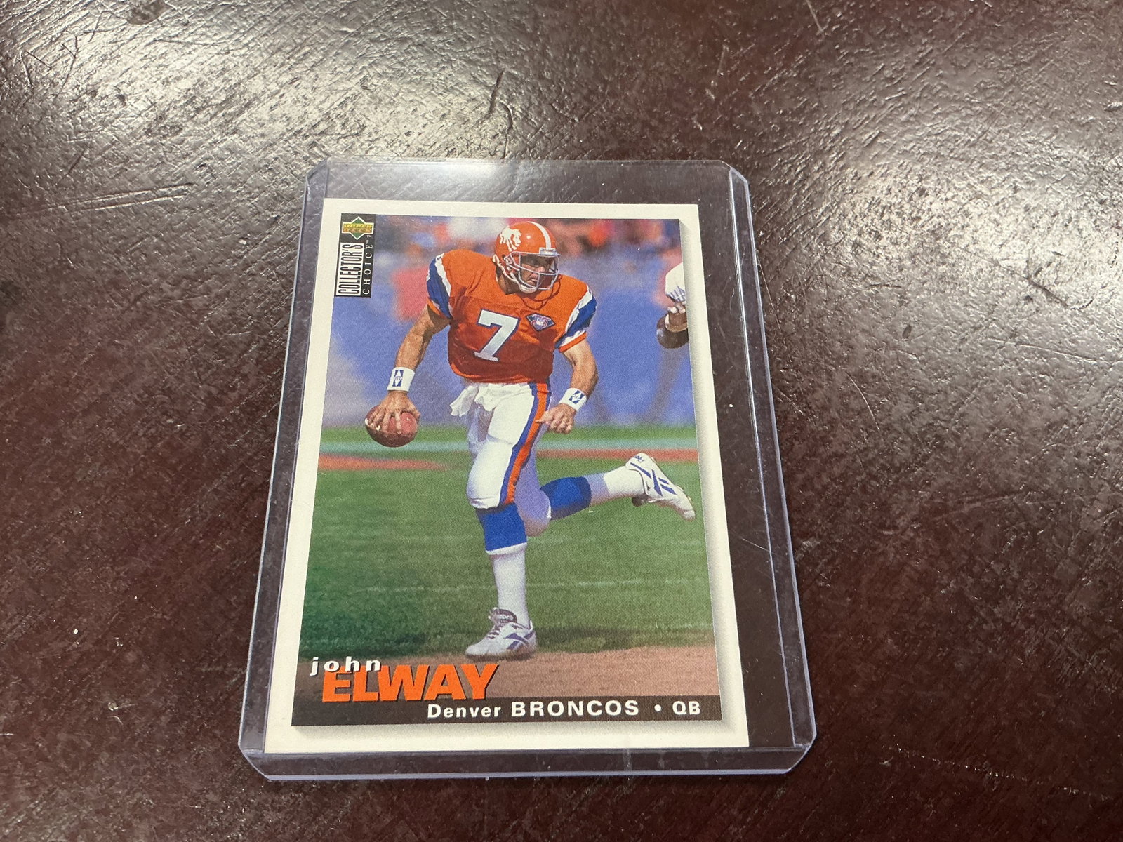 1995 Upper Deck Collectors Choice John Elway Broncos Card: 1995 Upper Deck Collectors Choice John Elway NFL football card featuring the Hall of Fame Denver Broncos quarterback in classic orange uniform. Strong display and nostalgia appeal tied to one of the