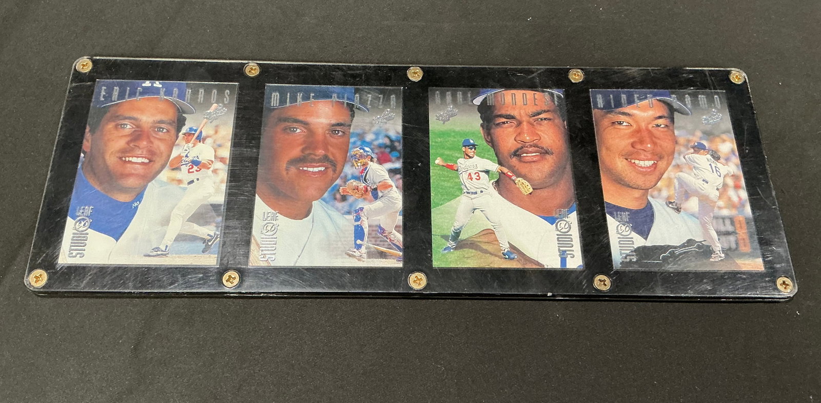 Dodgers Rookie Star Card Display Piazza Mondesi Nomo Karros: Mounted Los Angeles Dodgers rookie star display featuring Mike Piazza, Raul Mondesi, Hideo Nomo, and Eric Karros cards housed together in screw-down style presentation holder. Strong 1990s Dodgers col