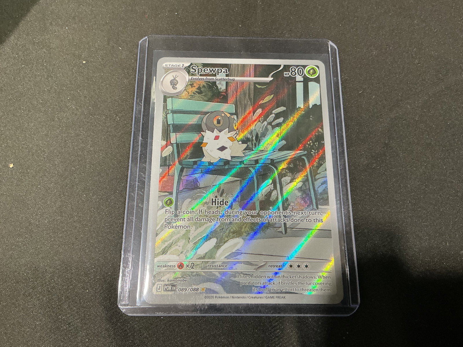 Pokemon Spewpa Full Art Holo Card 089/088: Pokemon Spewpa full art holo trading card numbered 089/088 featuring striking illustrated artwork with vivid rainbow foil pattern and modern Scarlet and Violet era styling. An eye catching