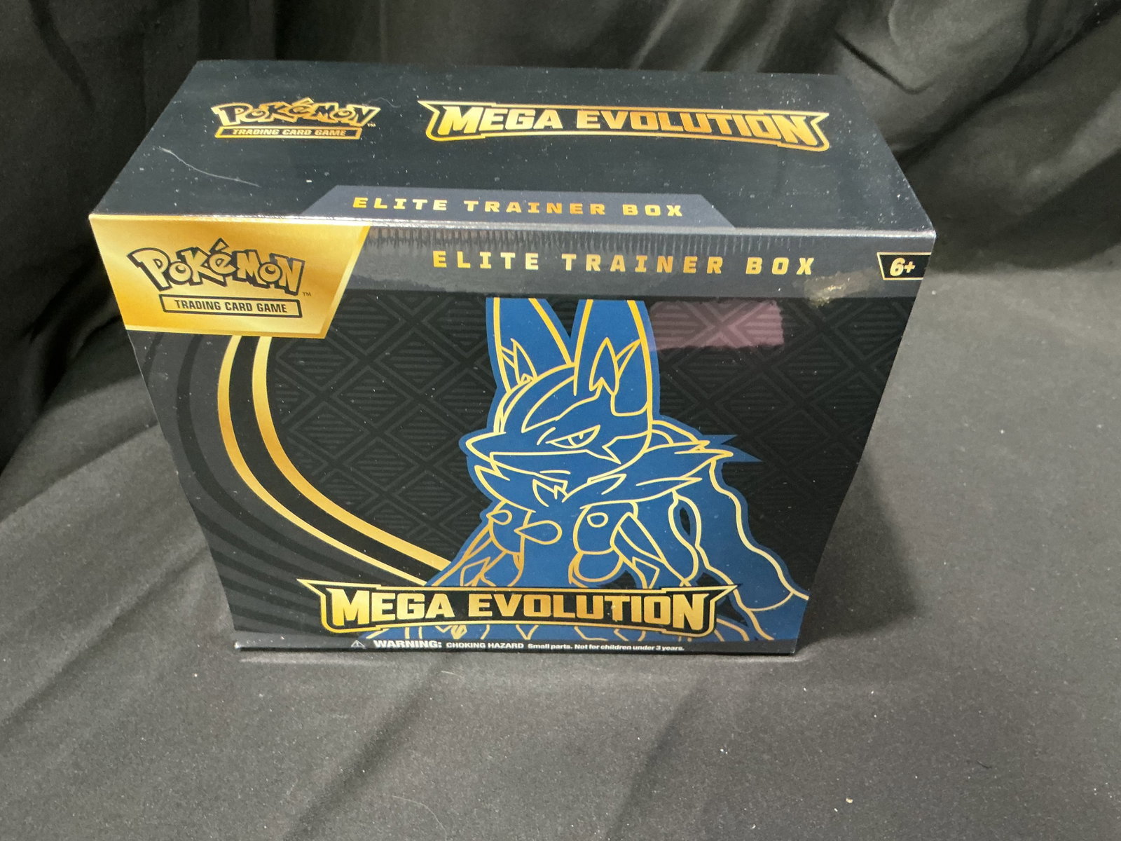 Pokemon Mega Evolution Elite Trainer Box Lucario: Factory sealed Pokemon Mega Evolution Elite Trainer Box featuring Lucario artwork and Mega Evolution themed contents including booster packs, sleeves, energy cards, dice, and accessories. Modern