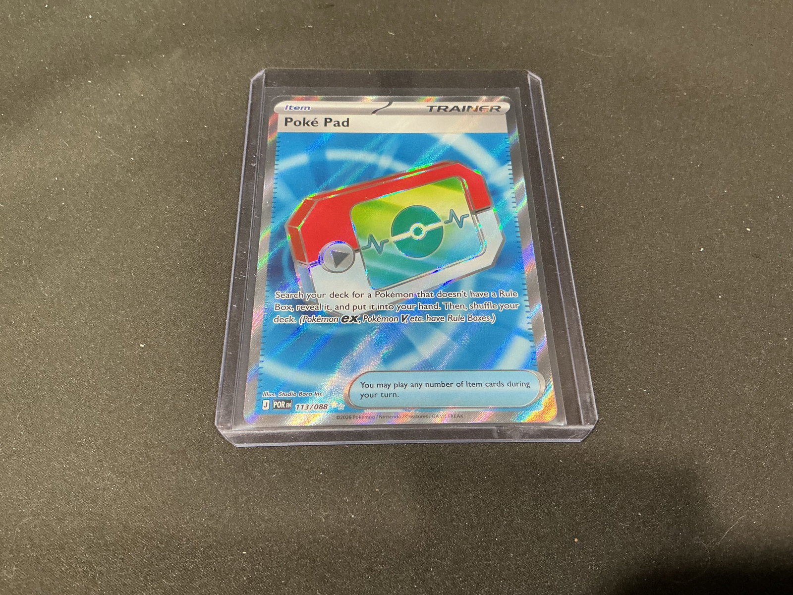 Pokemon Poke Pad Reverse Holo Trainer Card 113/088: Pokemon Poke Pad reverse holo trainer card numbered 113/088 from the Japanese Mega Evolution series. Features vibrant foil patterning with modern trainer card artwork and strong display appeal for Pok
