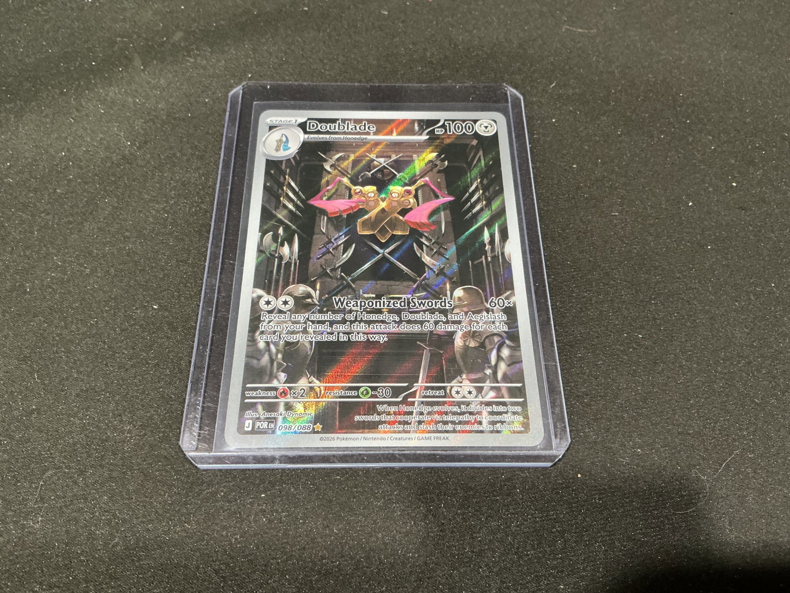 Pokemon Doublade Full Art Holo Card 098/088: Pokemon Doublade full art holo trading card numbered 098/088 featuring reflective foil artwork and detailed sword themed illustration. Sleeved and top loaded presentation suitable for collectors and m