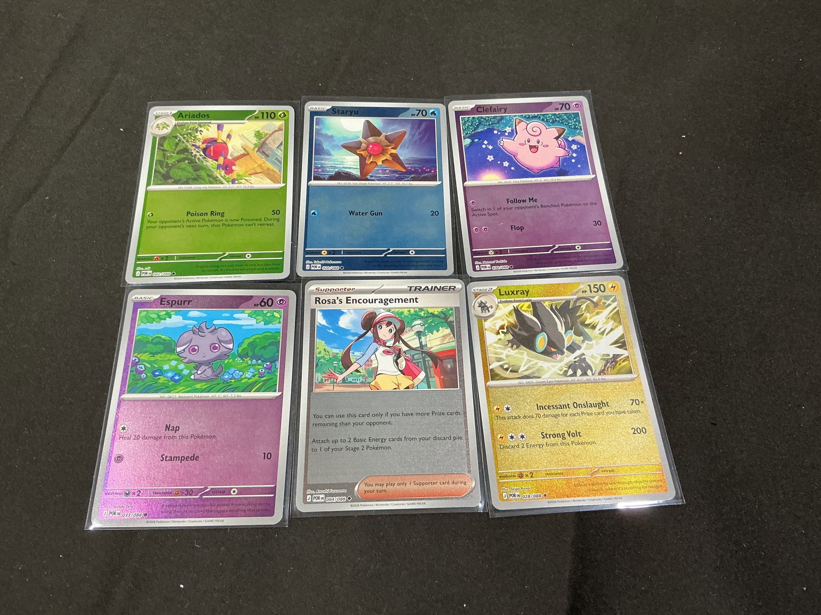 Pokemon Card Lot Luxray Rosa Clefairy & More: Pokemon trading card lot featuring Luxray holo, Rosa’s Encouragement trainer card, Clefairy, Ariados, Espurr, and Staryu cards from modern Japanese Mega Evolution Perfect Order series releases.