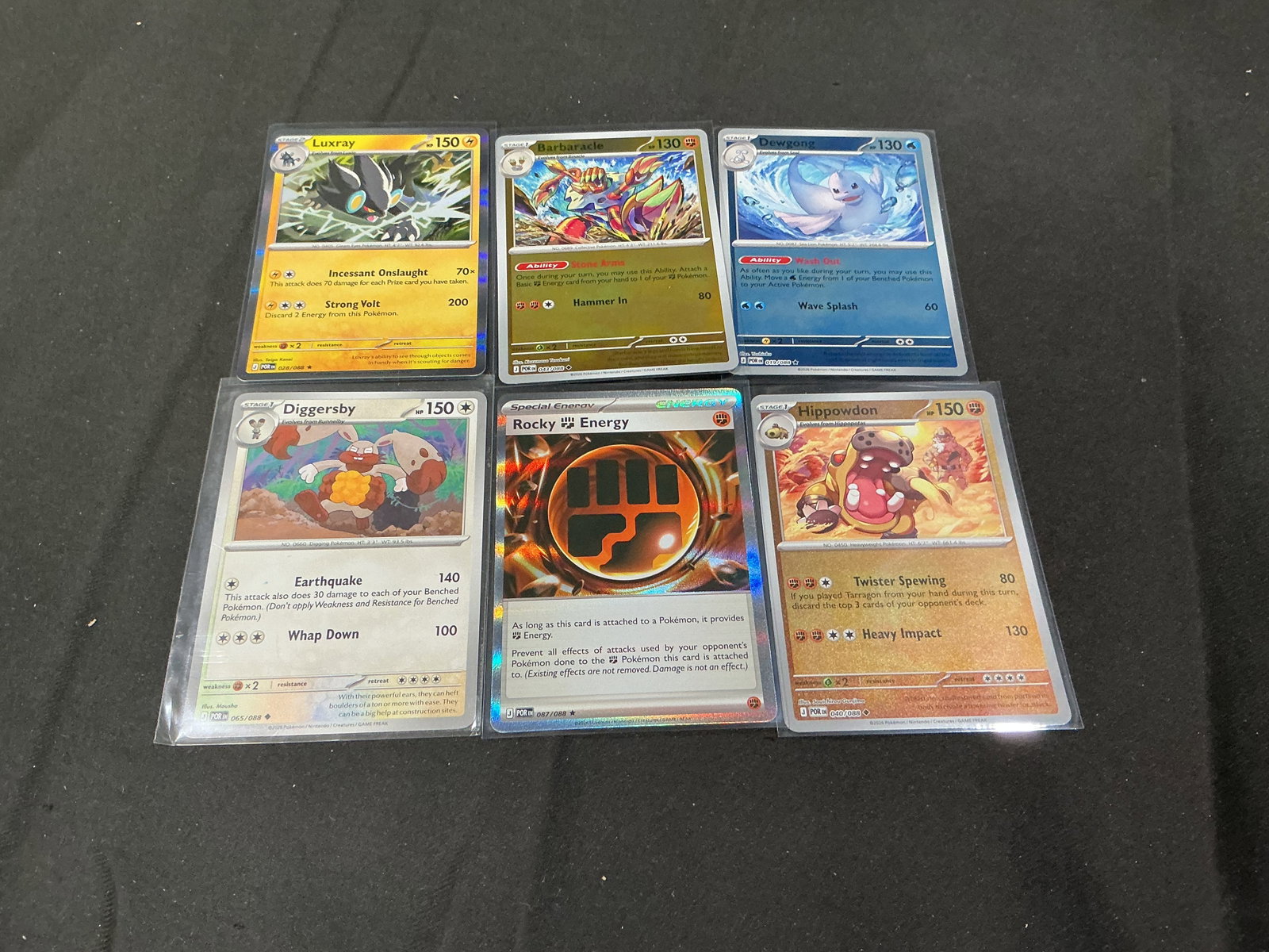 Pokemon Reverse Holo & Energy Card Lot Luxray Rocky Energy: Pokemon trading card assortment featuring reverse holo and special cards including Luxray, Rocky Energy, Hippowdon, Diggersby, Dewgong, and Barbaracle. Mixed modern Pokemon lot with foil finishes and 