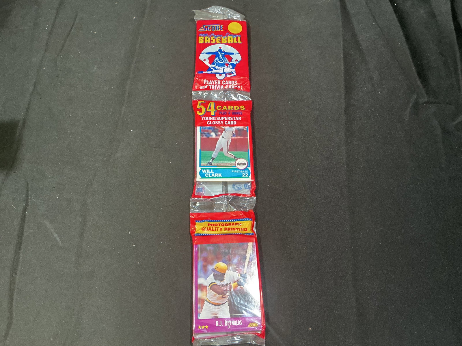 1990 Score Baseball Wax Pack Will Clark R.J. Reynolds: Vintage sealed 1990 Score Baseball wax pack featuring Will Clark and R.J. Reynolds on the wrapper panels. Includes 54 cards plus bonus young superstar glossy card. Popular early 1990s baseball release