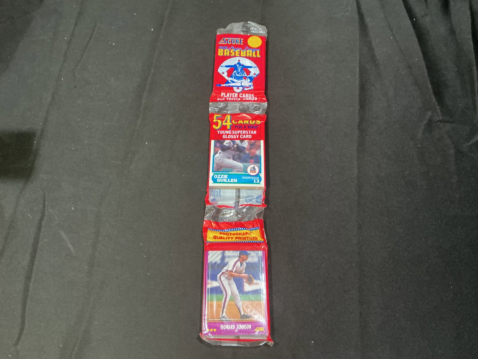 1990 Score Baseball Rack Pack Ozzie Guillen Howard Johnson: Sealed 1990 Score Baseball rack pack featuring visible Ozzie Guillen and Howard Johnson cards on packaging. Includes 54 cards plus bonus glossy card from the popular early 1990s Score release with