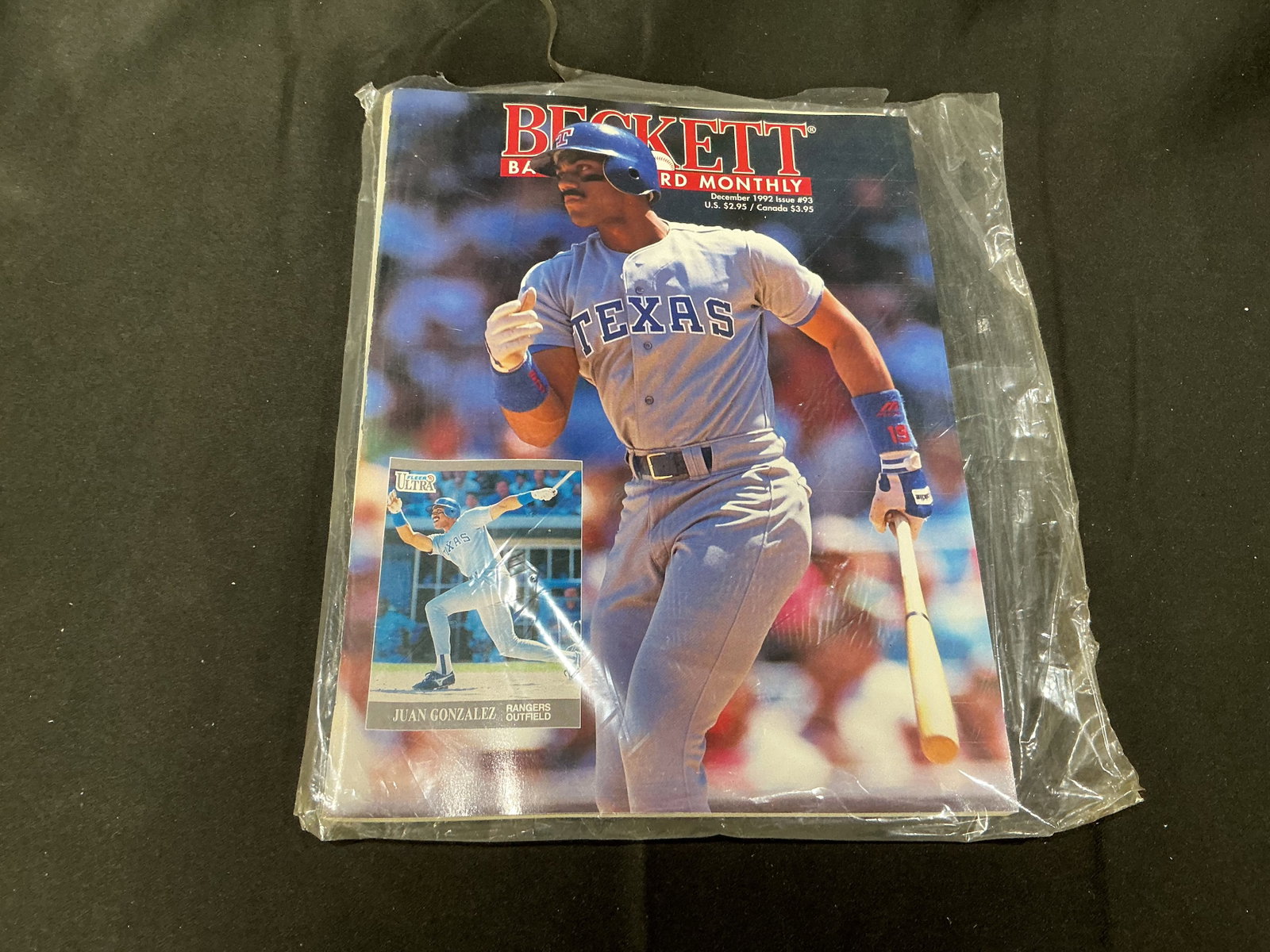 Beckett Baseball Card Monthly December 1992 Juan Gonzalez Sealed Issue: Vintage Beckett Baseball Card Monthly December 1992 issue featuring Texas Rangers slugger Juan Gonzalez on the cover. Sealed sports card publication with strong baseball memorabilia appeal.