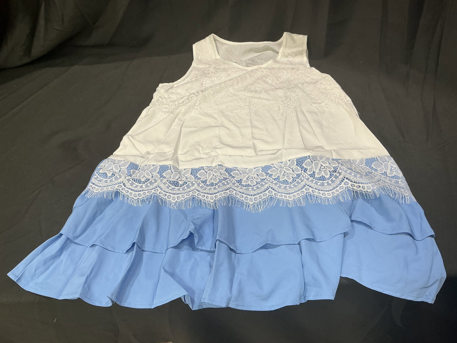Womens White and Light Blue Lace Trim Dress Size Large: Womens white and light blue layered dress with lace trim accents and cold shoulder styling. Includes original packaging. Size large polyester construction with flowing tiered design.