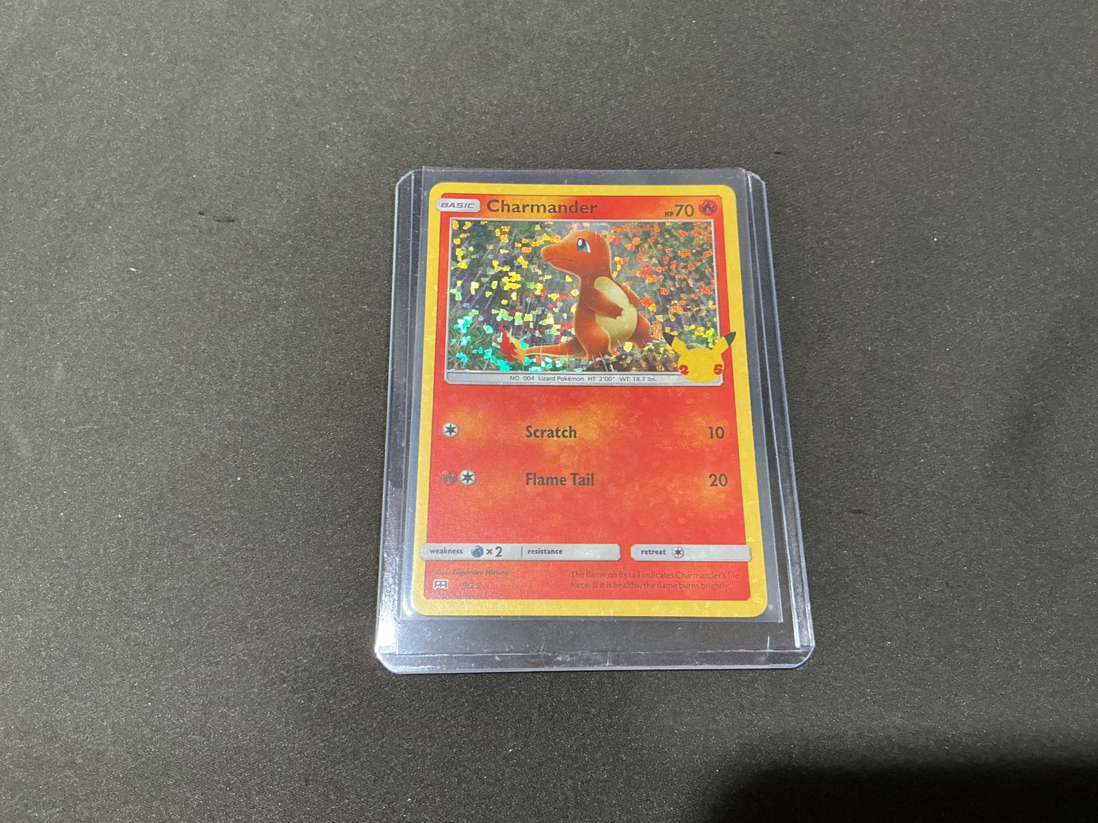 Pokemon Charmander 5/25 McDonalds Holo Promo Card: Back again after a successful prior auction appearance, this Pokemon Charmander holographic promotional card from the McDonalds 25th Anniversary set features colorful confetti holo presentation and