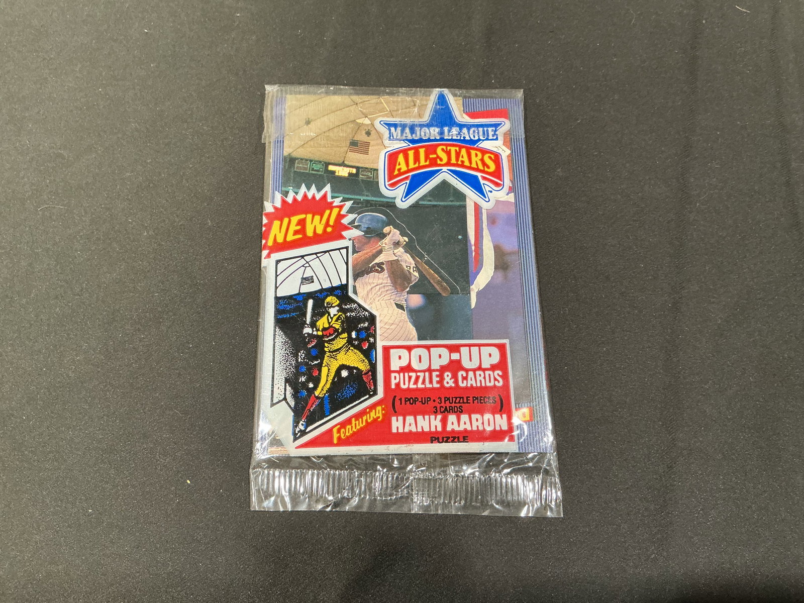 Major League All-Stars Hank Aaron Pop-Up Puzzle Cards Pack: Sealed Major League All-Stars pop-up puzzle and cards pack featuring Hank Aaron puzzle graphics and vintage baseball themed presentation. Fun unopened novelty pack with retro baseball card appeal and 
