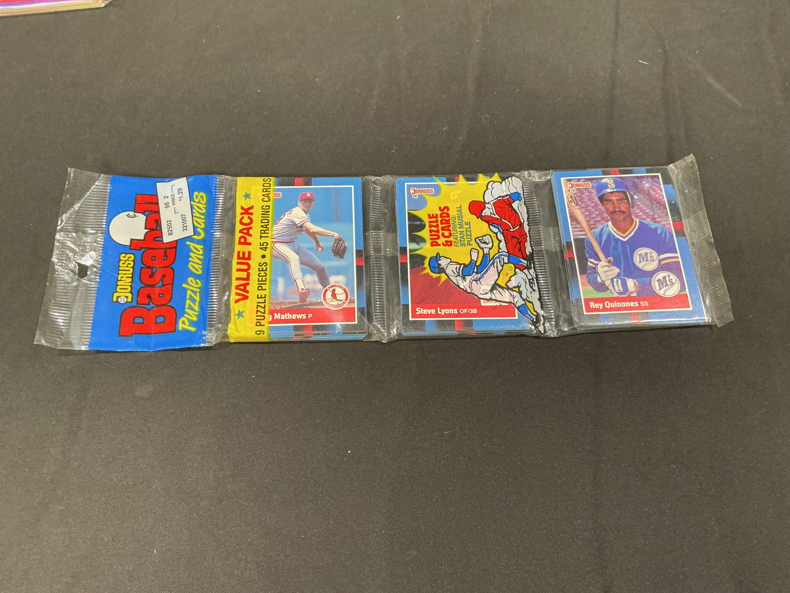 1988 Donruss Baseball Puzzle & Cards Sealed Value Pack: Vintage 1988 Donruss Baseball Puzzle and Cards value pack featuring visible Randy Mathews and Rey Quinones cards along with puzzle insert contents. Classic late-1980s sealed baseball card presentation
