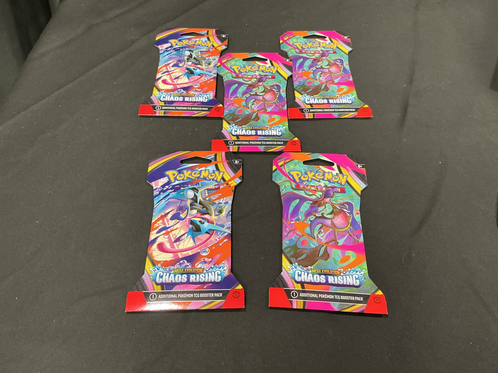 Pokemon Mega Evolution Chaos Rising Booster Pack Lot: Group lot featuring five sealed Pokemon Mega Evolution Chaos Rising single booster packs with assorted pack artwork. Modern Pokemon TCG sealed product with strong appeal for rip-and-ship buyers,