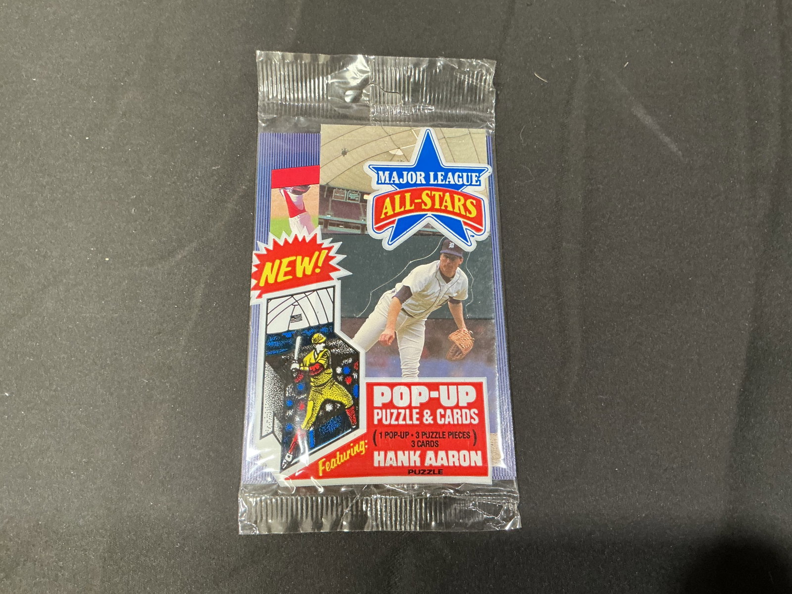 Sealed Major League All-Stars Hank Aaron Puzzle & Cards Pack: Factory sealed Major League All-Stars puzzle and card pack featuring baseball legend Hank Aaron. Includes pop-up puzzle pieces and collectible cards in unopened original packaging. Nostalgic sports co