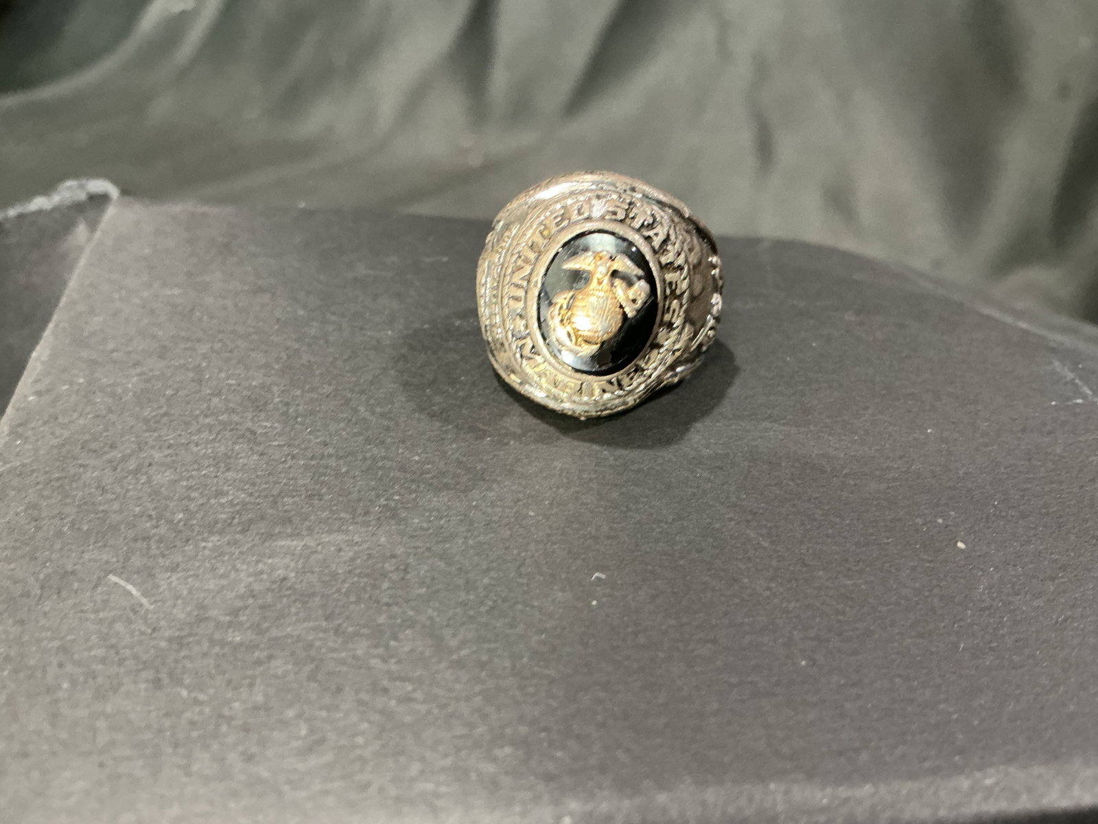 United States Marine Corps Dress Ring Vintage: Vintage United States Marine Corps dress ring featuring the iconic Eagle, Globe and Anchor emblem in raised detail against a dark center stone. Military collectible with strong patriotic display appea