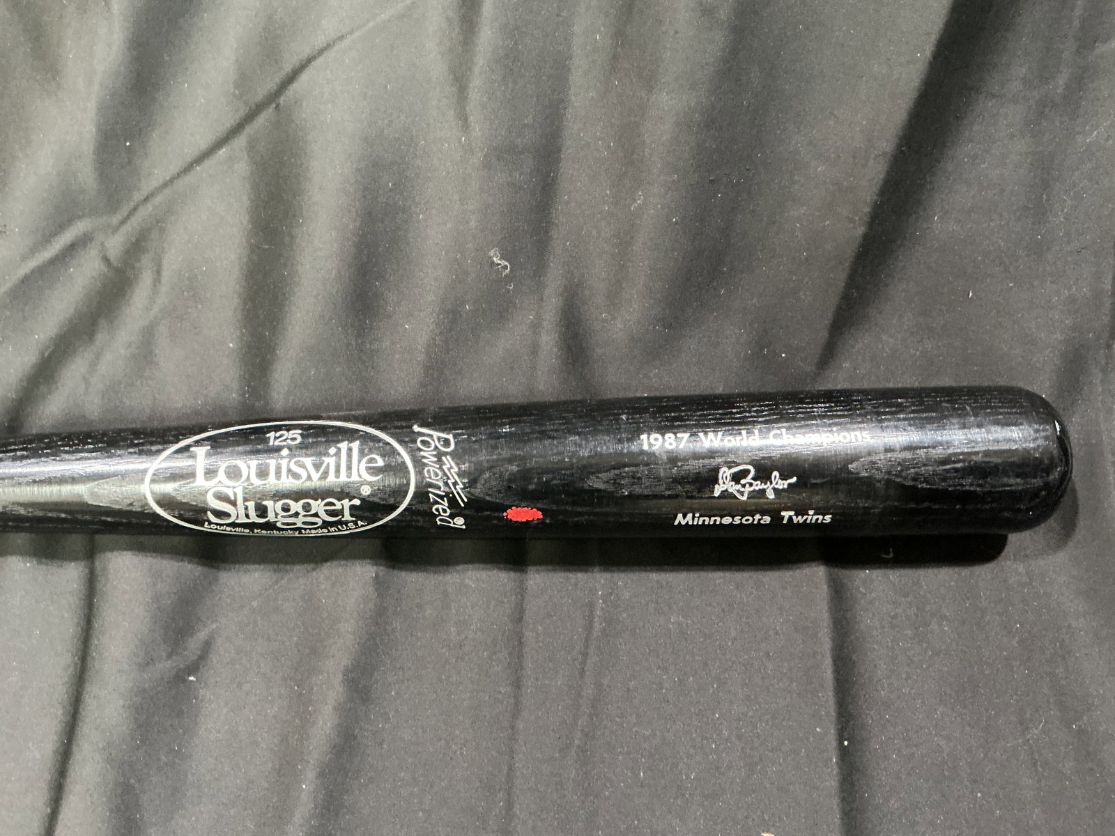 1987 Minnesota Twins World Champions Louisville Slugger Black Souvenir Bat: Black Louisville Slugger Powerized souvenir baseball bat commemorating the 1987 World Champion Minnesota Twins. Returning favorite from a prior offering with continued vintage baseball display appeal.