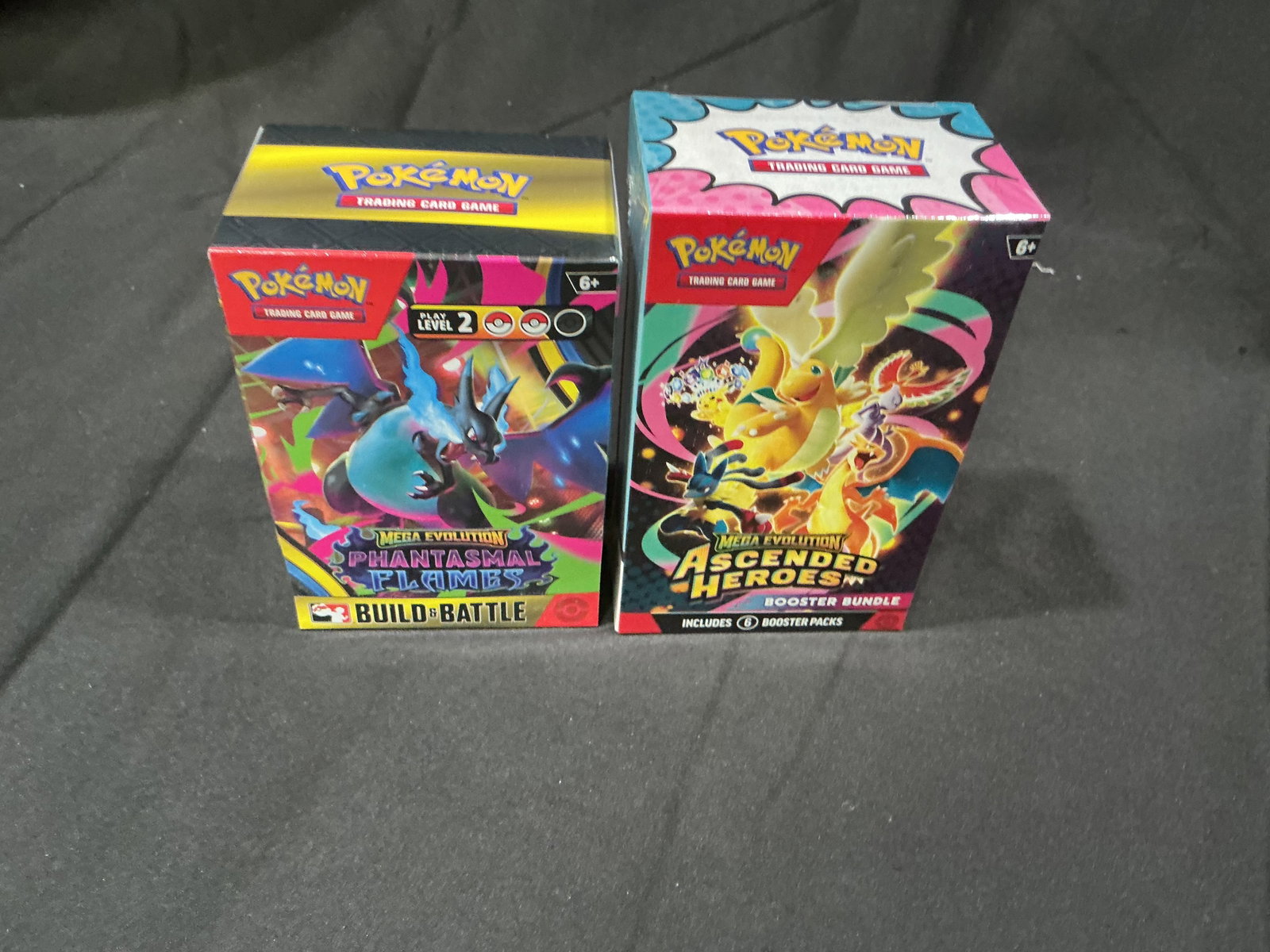 Pokemon Mega Evolution Booster Bundle & Build Battle Box Lot: Factory sealed Pokemon lot featuring a Mega Evolution Phantasmal Flames Build & Battle box alongside a Mega Evolution Ascended Heroes booster bundle. Includes modern sealed Pokemon product with strong