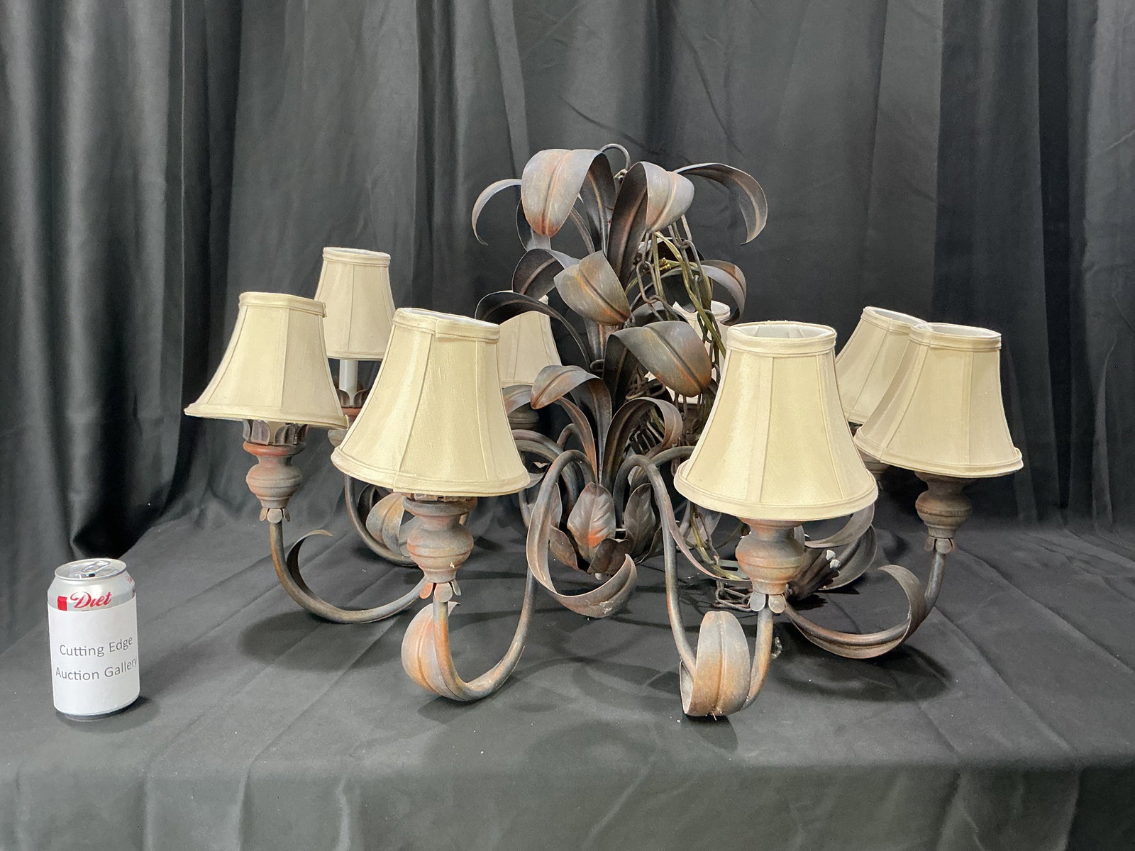 Rustic Iron 8-Light Chandelier with Fabric Shades: Rustic wrought iron chandelier featuring eight lights with cream fabric shades, scrolling arms, decorative leaf accents, and distressed bronze-brown finish. Returning after a lengthy absence from our