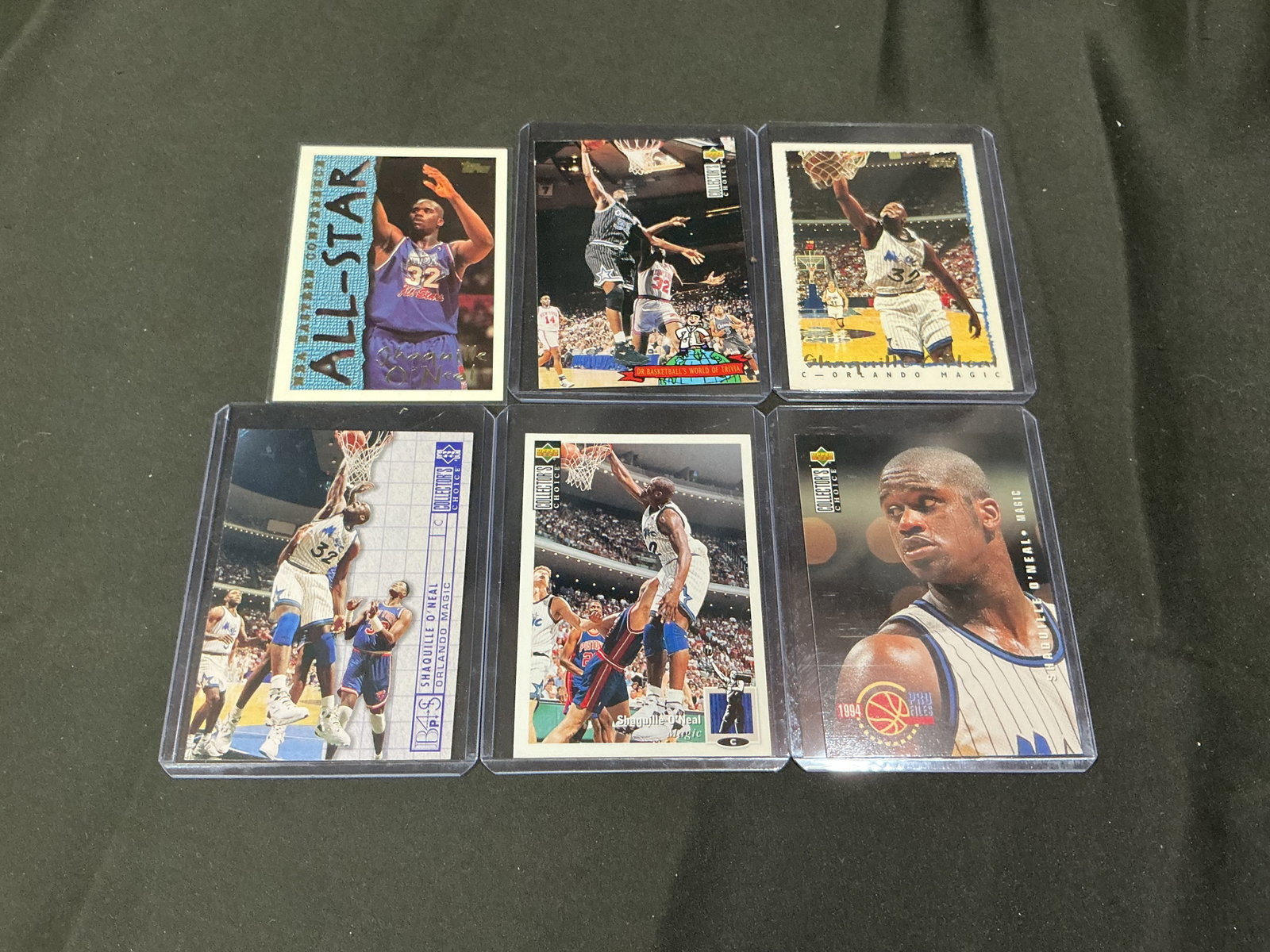 Shaquille O'Neal Card Collection Group: Six-card Shaquille O'Neal collection featuring Upper Deck, Collector's Choice, Topps, and Pro Files releases from his early Orlando Magic years. Includes All-Star, trivia, profile, and action card